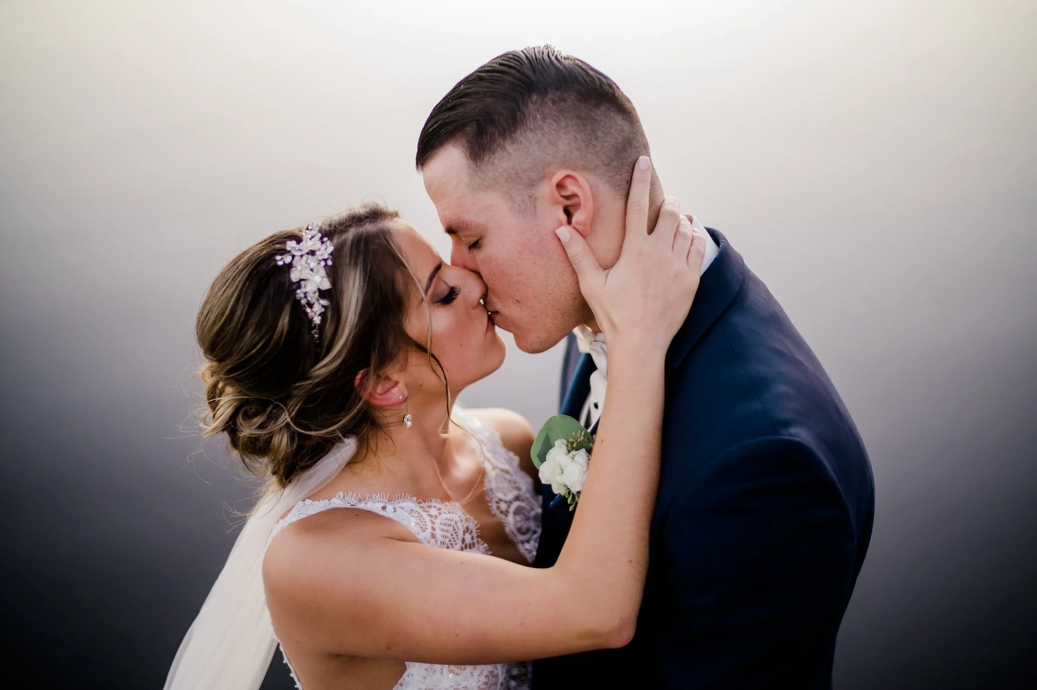 Bride and groom kissing on their wedding day.