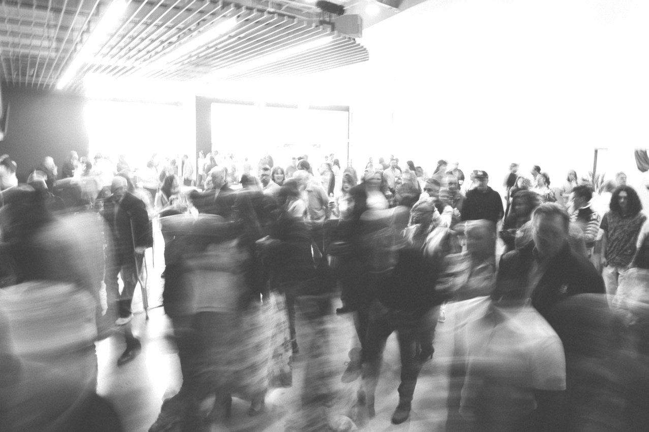 Blurred crowd of people in a bright indoor setting