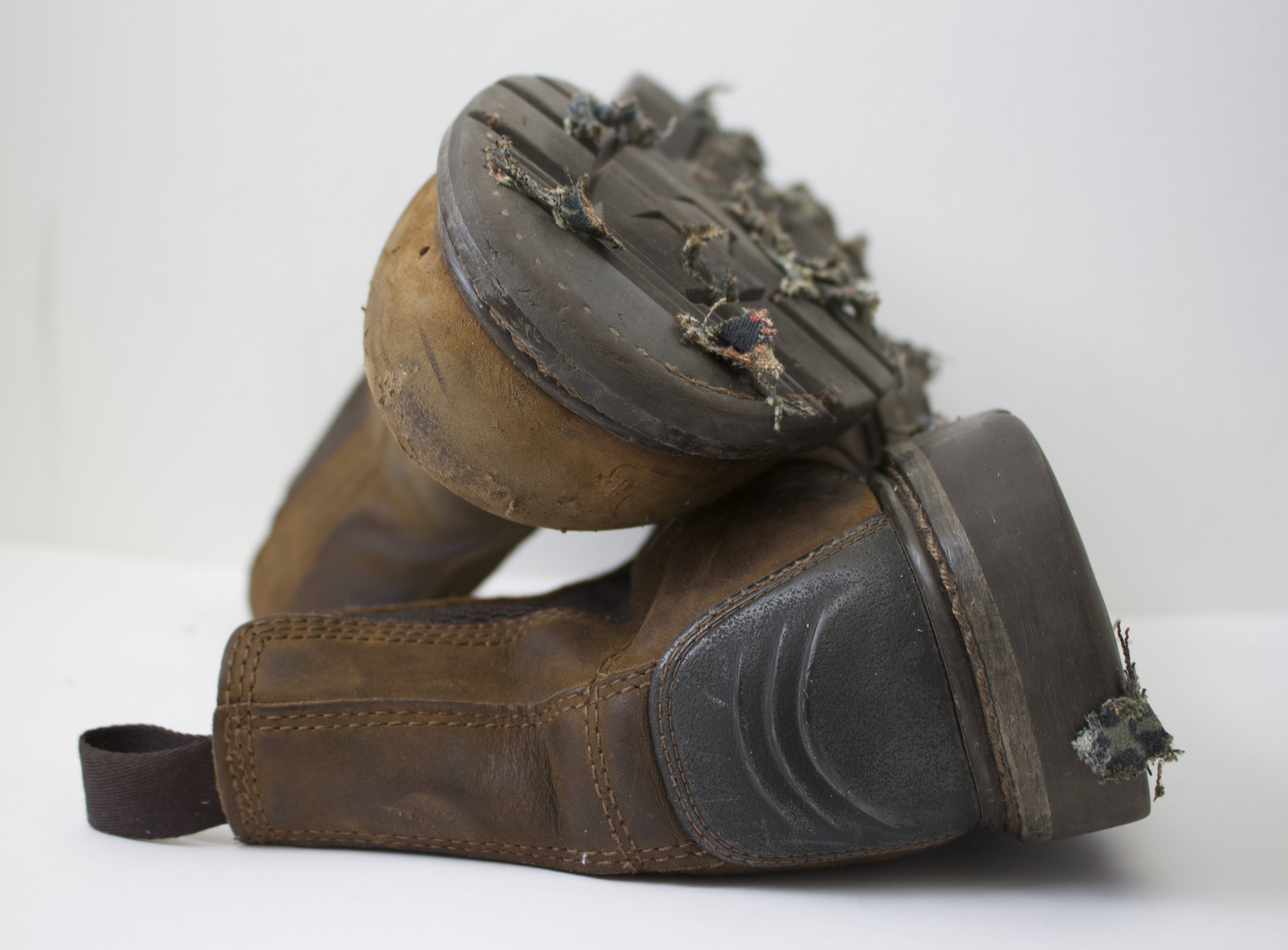 Tech Shoes, 2026. Work boots, distressed William Morris patterned fabric, other debris—36 x 32 x 23cm