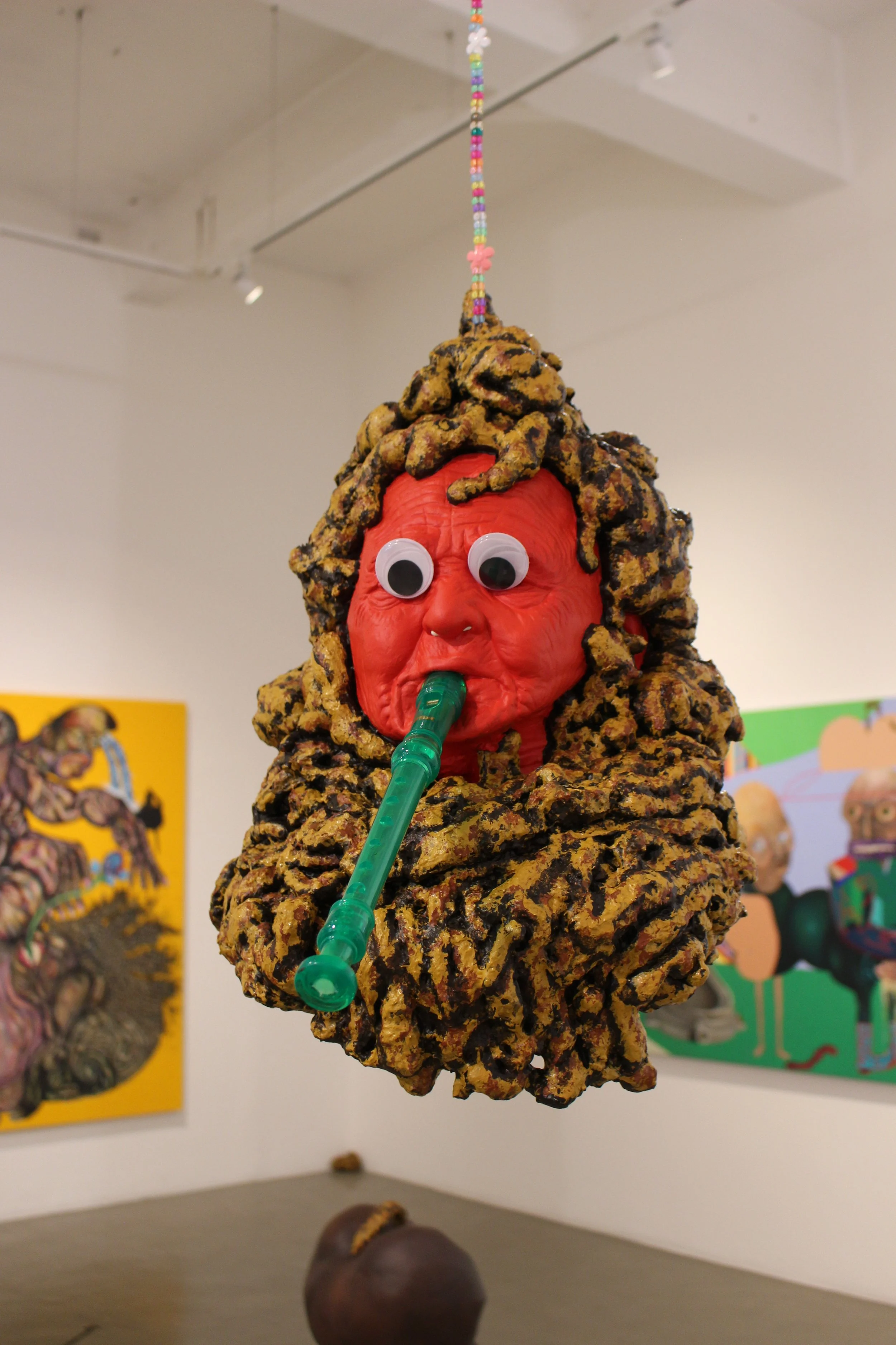 Poohead, 2023. Expanding foam, googly eyes, head mask, acrylic paint, acrylic beads, recorder — 55 x 31 x 37 cm
