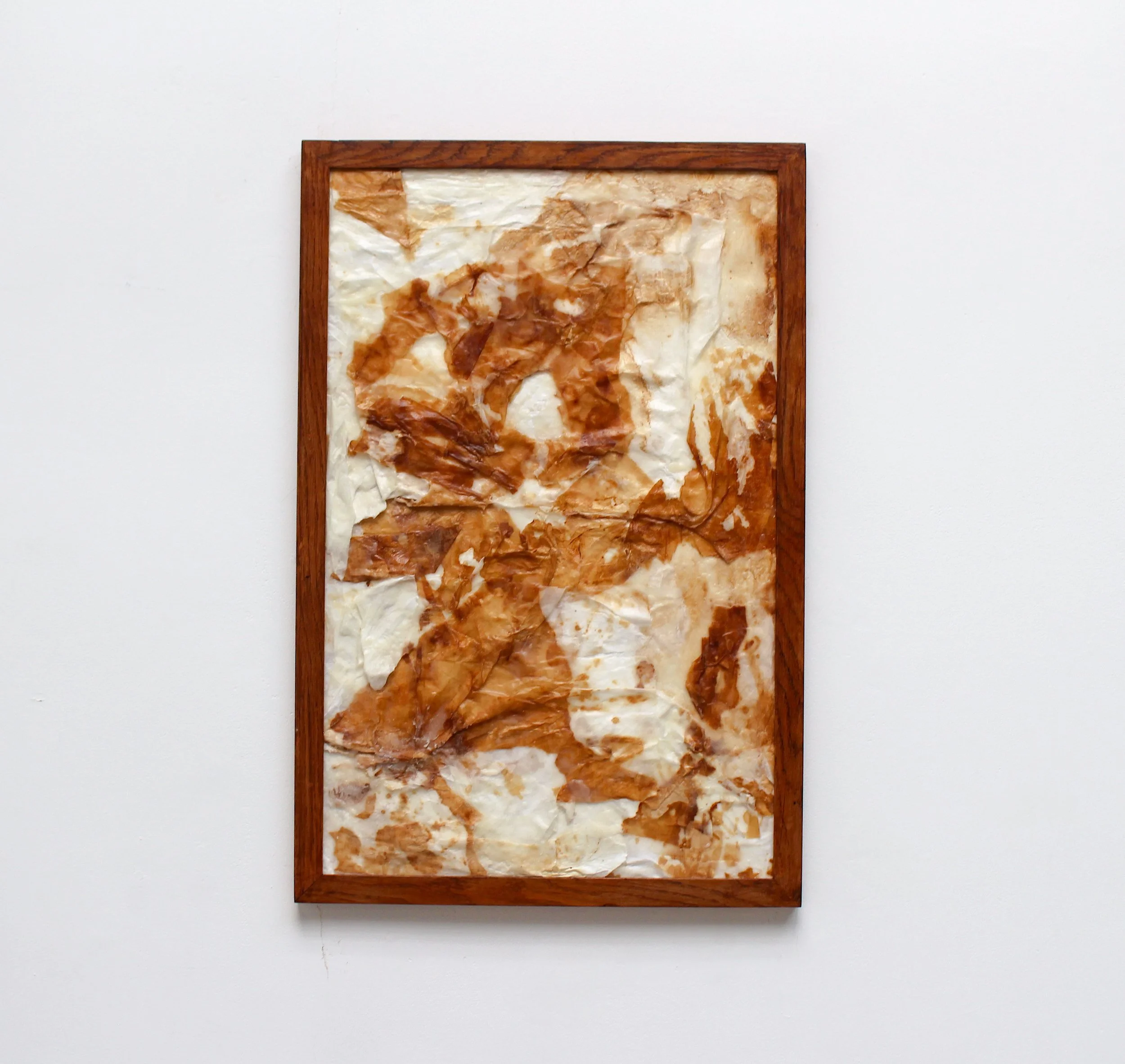 Residue,  2026. Hanji (Korean calligraphy paper) stained with soy sauce, wax, plywood, wooden frame—58 x 78.5cm
