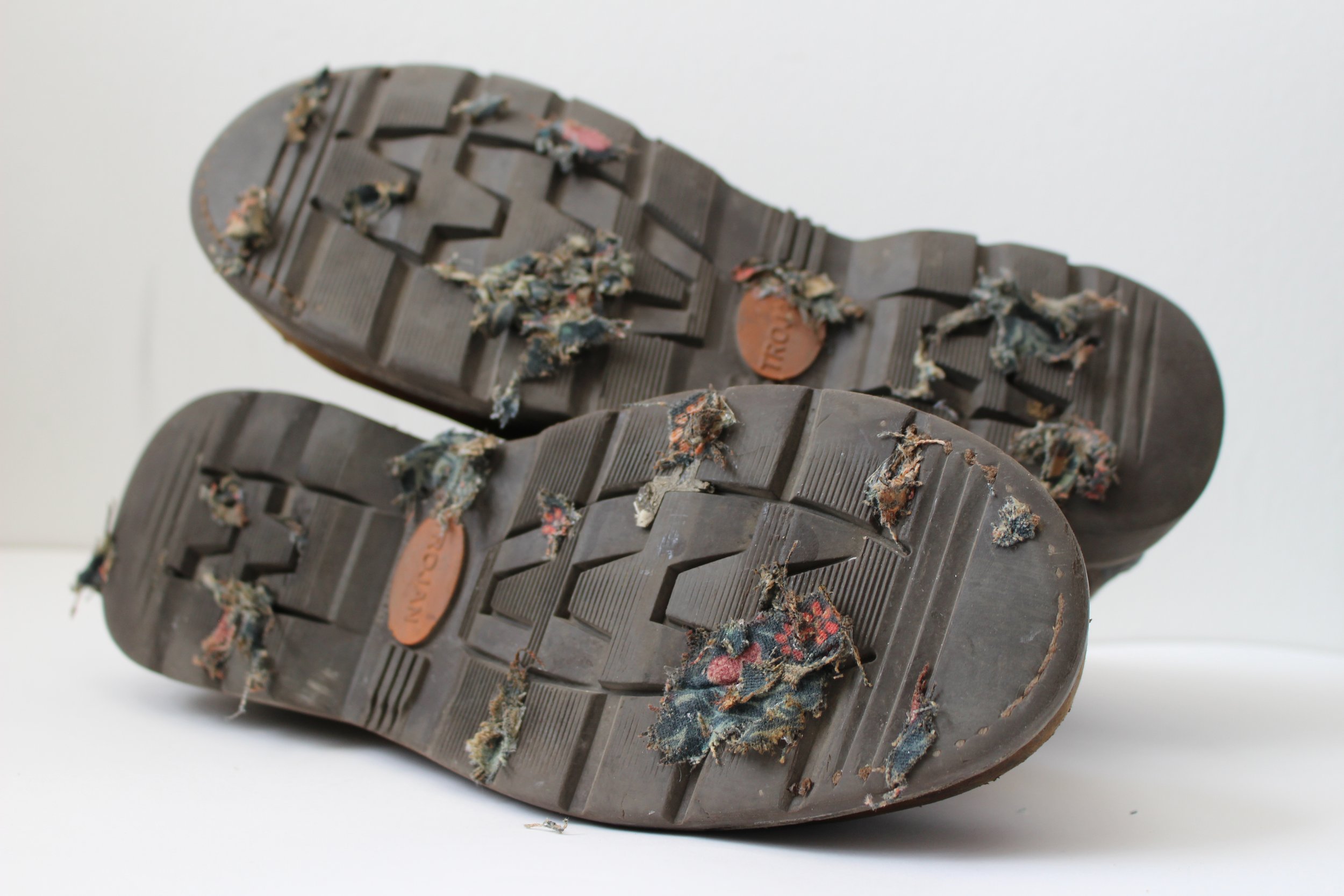 Tech Shoes, 2026. Work boots, distressed William Morris patterned fabric, other debris—36 x 32 x 23cm