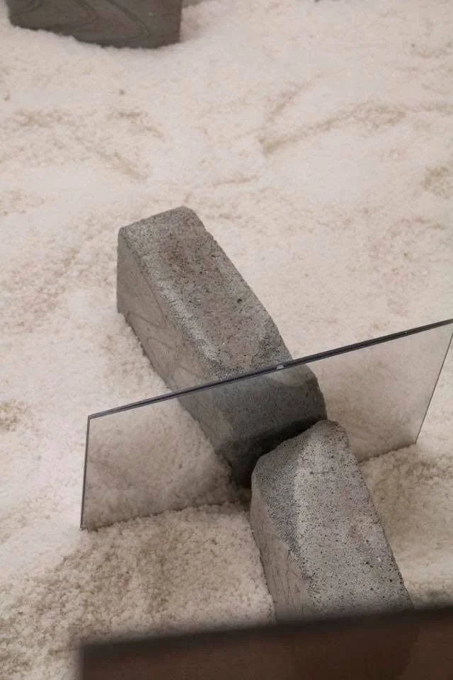 Lot's Wife, 2018. Jesmonite, fibre glass, bricks, mirrors, trolley wheels, metal bars, spray paint, acrylic sheet, bricks, salt— Variable dimensions
