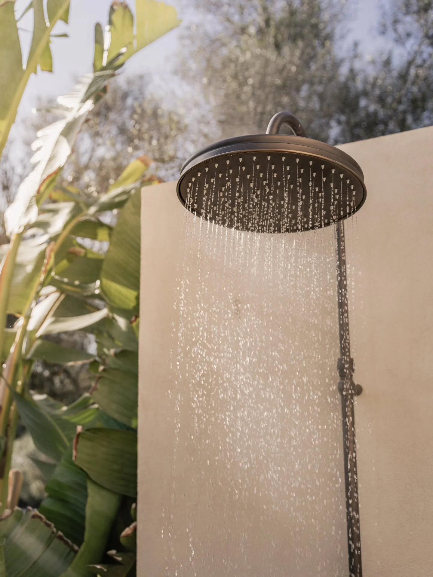 Not every wall divides. 
Some dissolve &mdash; 
like glass opening to sky, 
like water meeting stone. 

This shower, under the open air, 
is more than a gesture of design. 
It is dialogue. 
Between the quiet of the interior 
and the wild pulse of the