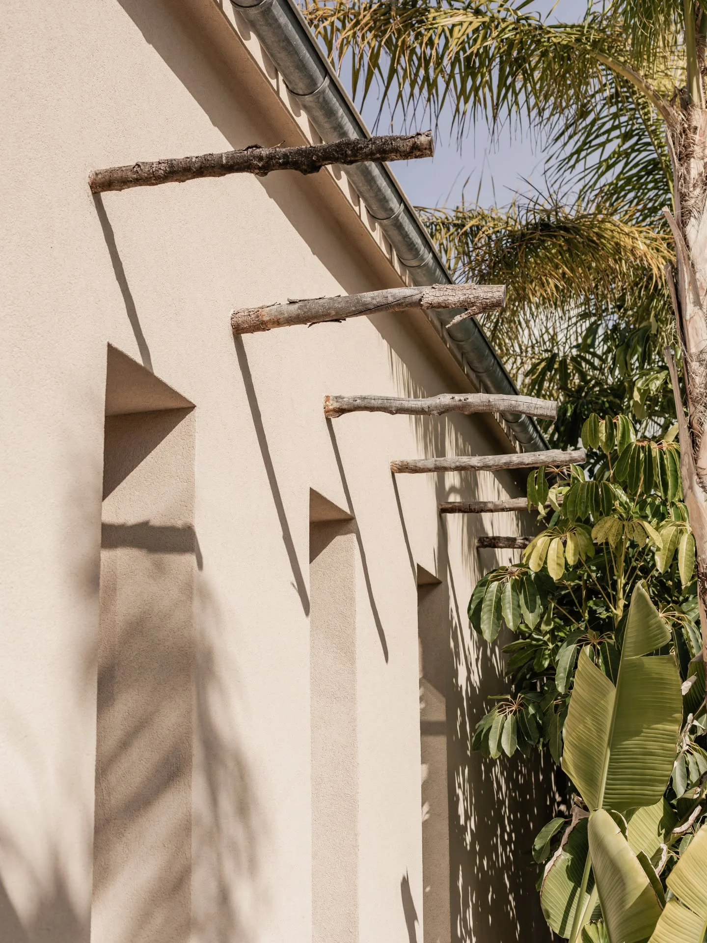 Not every detail is invented. 
Some are remembered &mdash; 
wood reborn as ornament, 
stone given voice again. 

The sticks once meant for shelter 
now pierce the walls as quiet accents, 
marks of a tradition that refuses to fade. 

This is not nosta