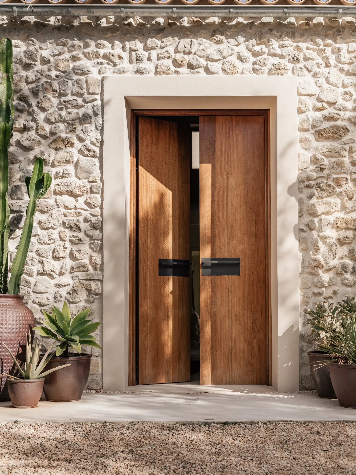 Not every door closes. 
Some invite &mdash;
like light finding its way through stone, 
like shade resting on wood. 

This threshold is not just passage. 
It is pause. 
A line between the rooted silence of tradition 
and the living presence of today. 