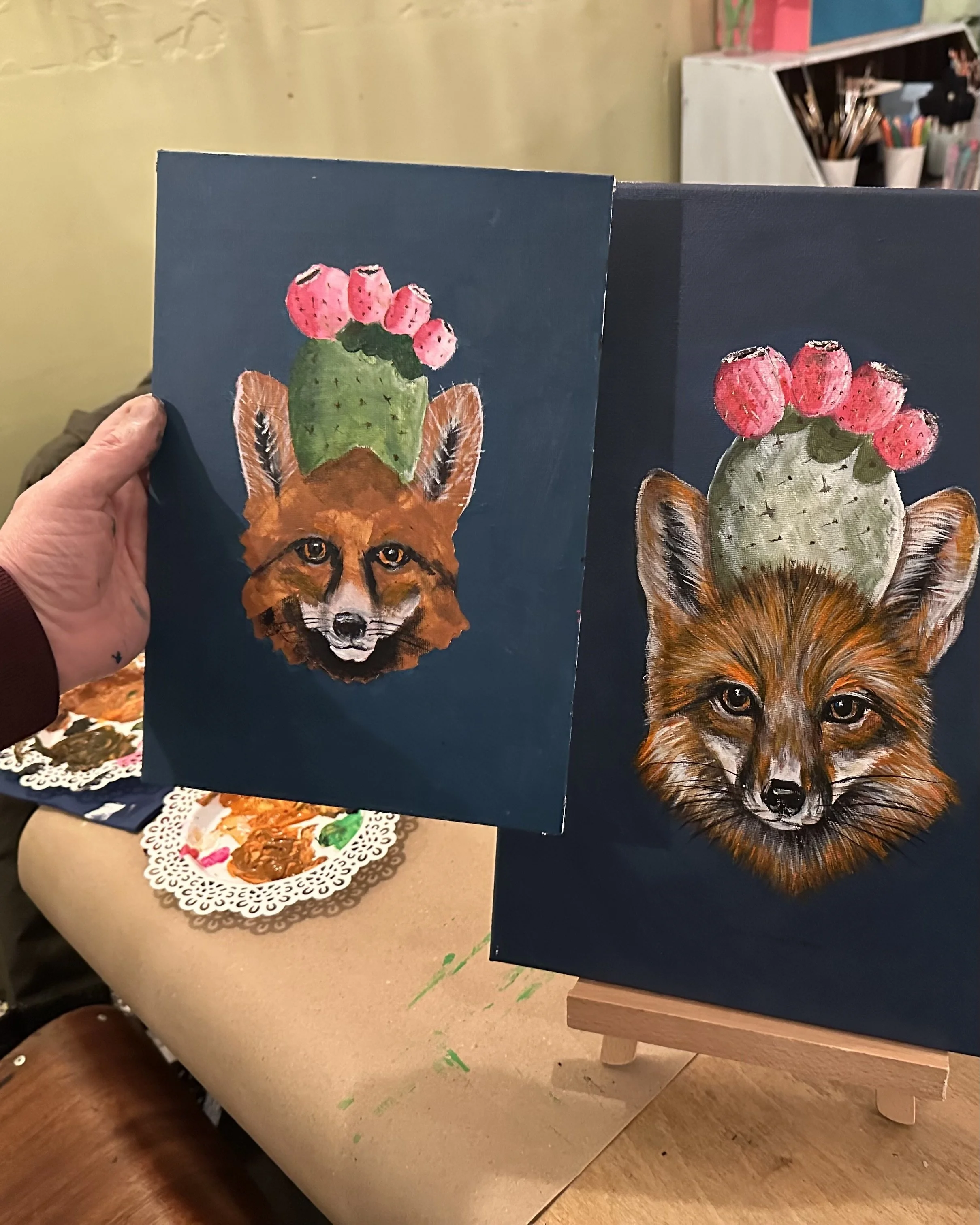 Paintings of a fox with a cactus topped with pink flowers on its head, depicted on dark backgrounds.