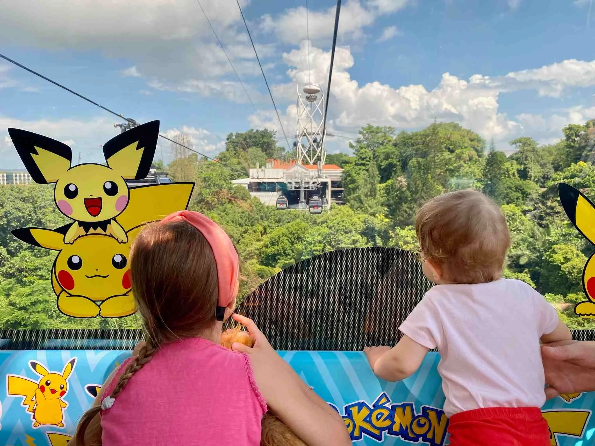 Kinder schauen aus der Seilbahn in Singapur.