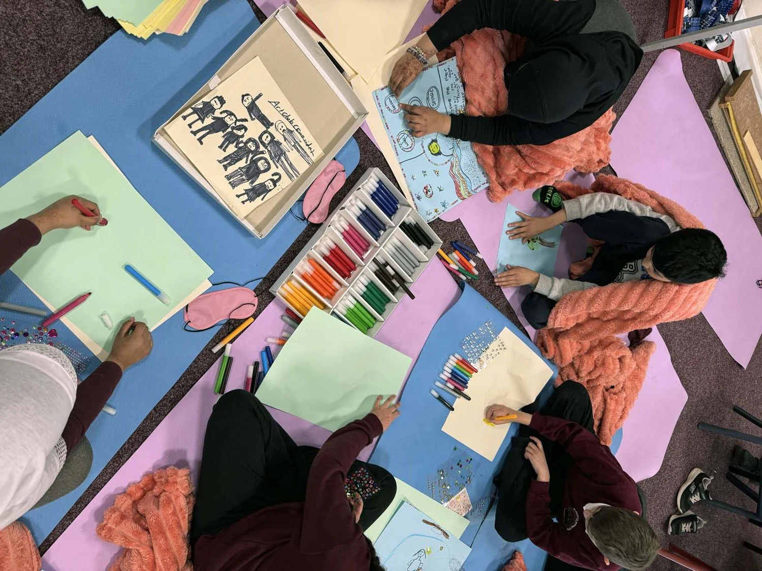 Children at St Mary's Primary School participating in the Conscious Sculpture Art Club workshop around a activity table.
