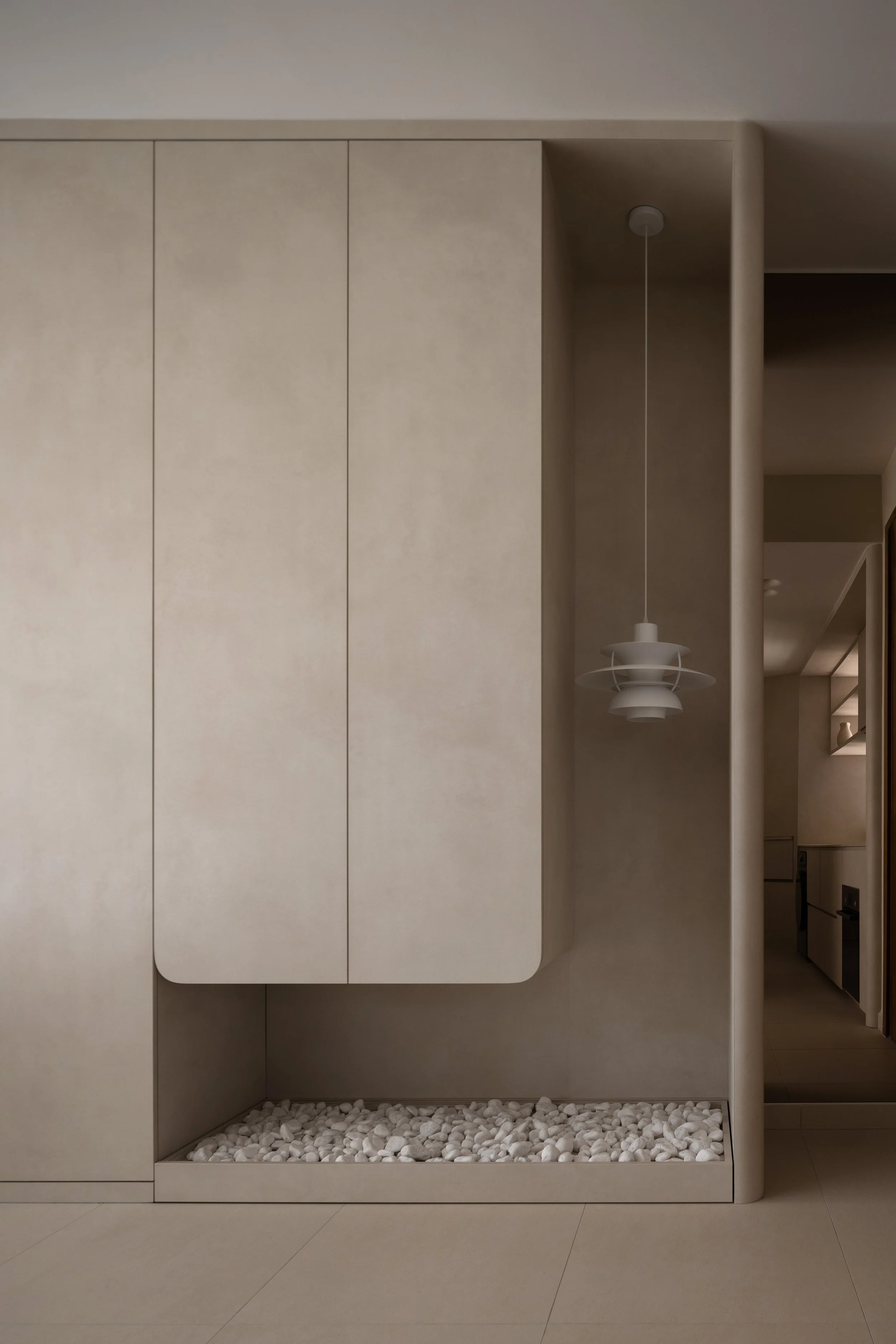 Minimalist interior with beige cabinetry, a white pebble base, and a hanging white pendant lamp.