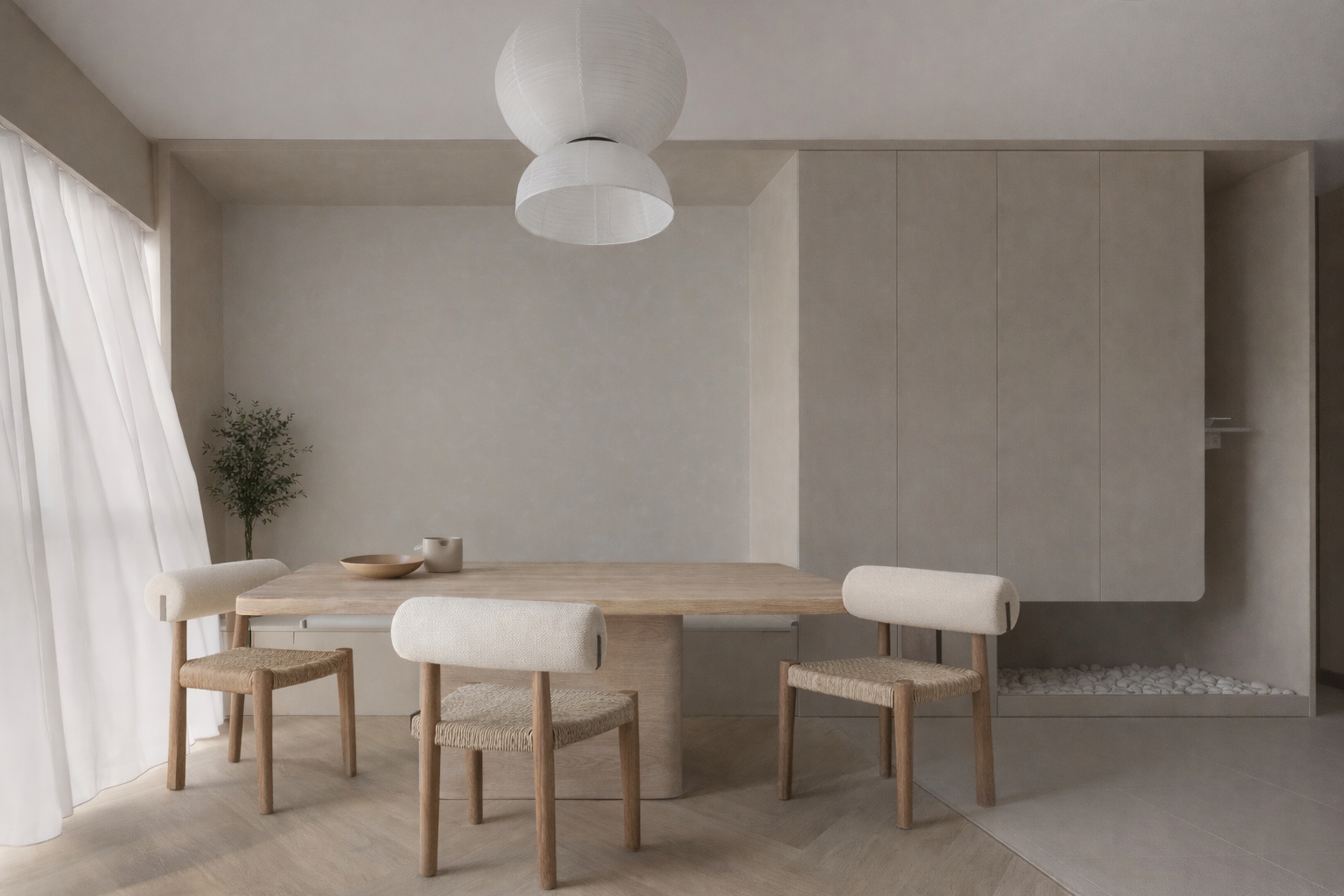 Minimalist dining room with a wooden table, four beige upholstered chairs, a potted plant in the corner, white curtains on the left, and a built-in cabinet on the right