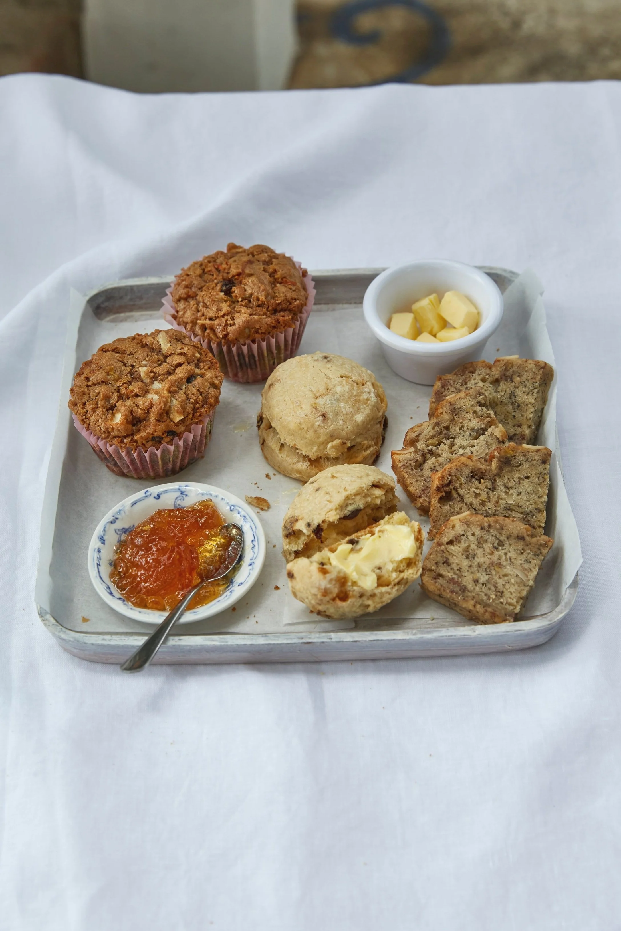 Baked breakfast goods on a white serving tray.