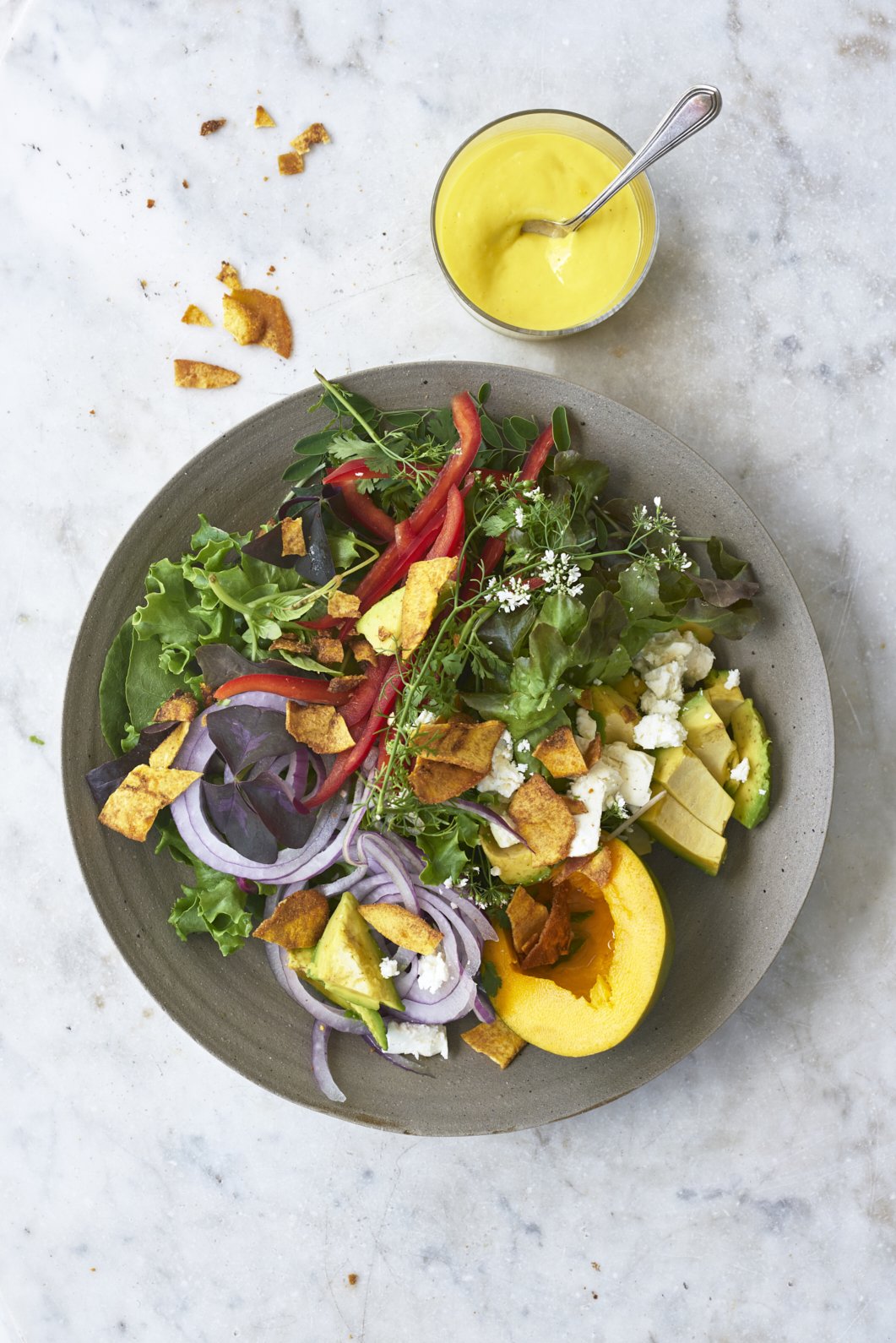 Salad in a gray ceramic plate.