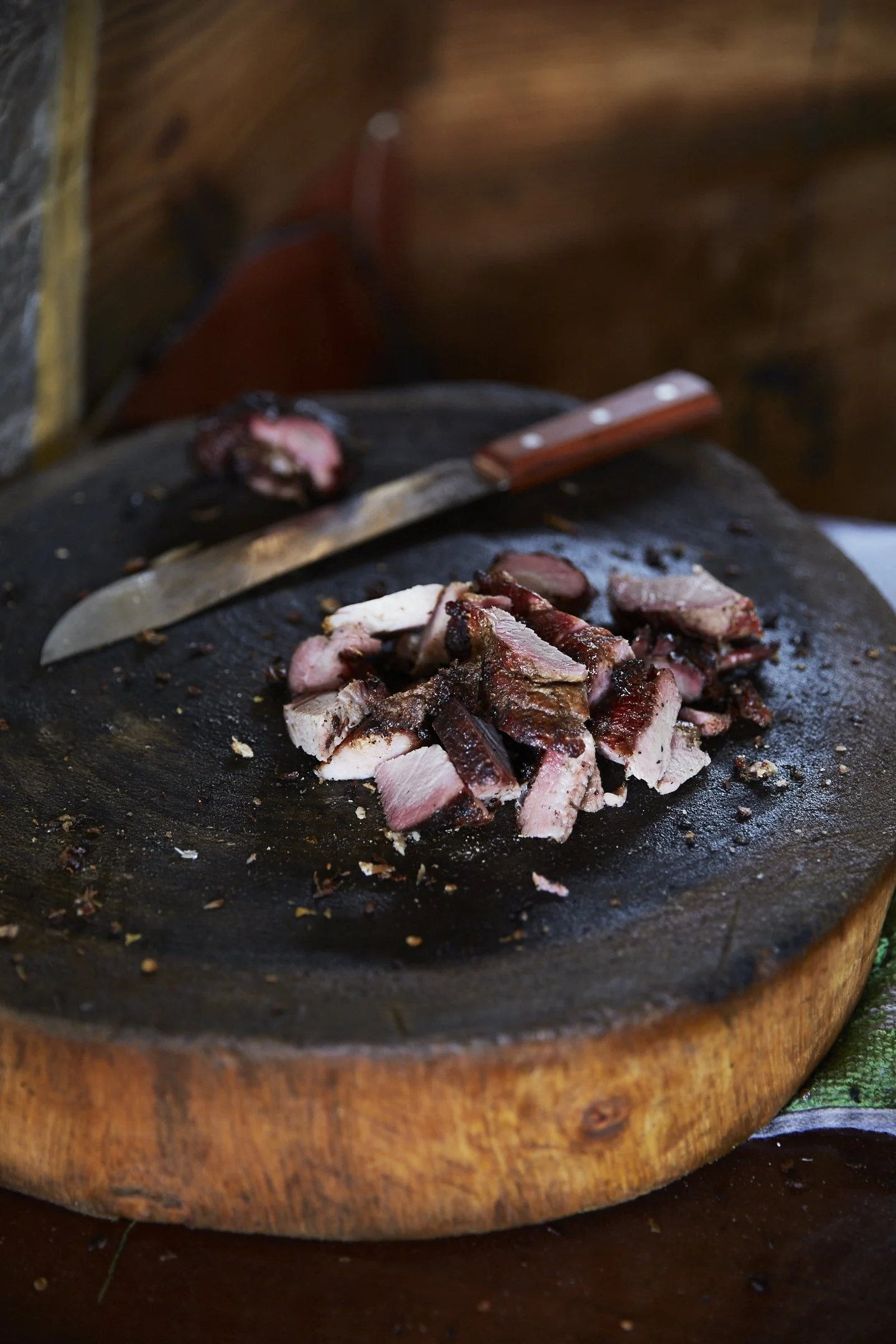 Meat on a wooden chopping block.