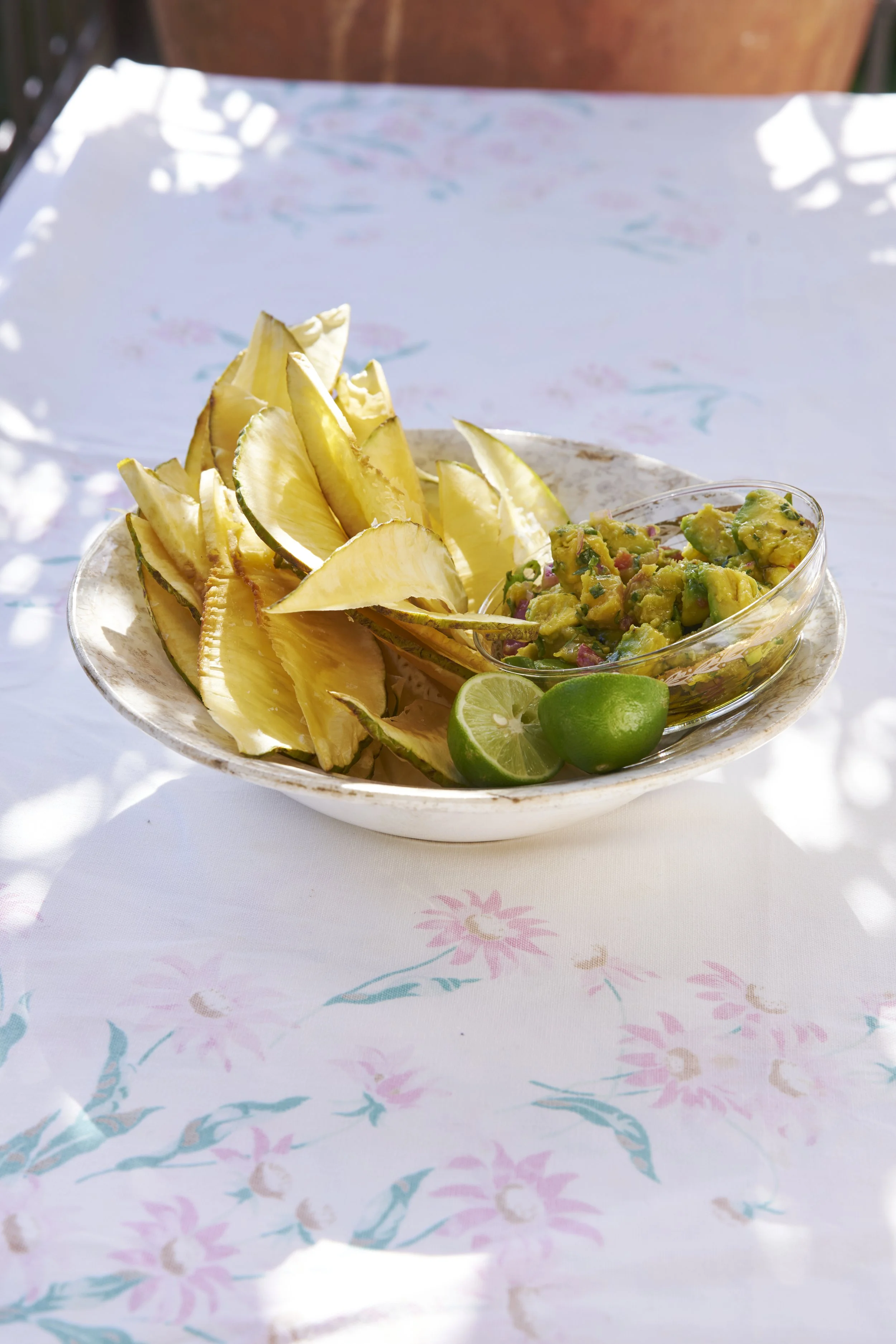 Chips and a dip in a ceramic bowl.