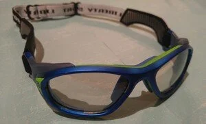 Blue and green sports goggles with a black strap