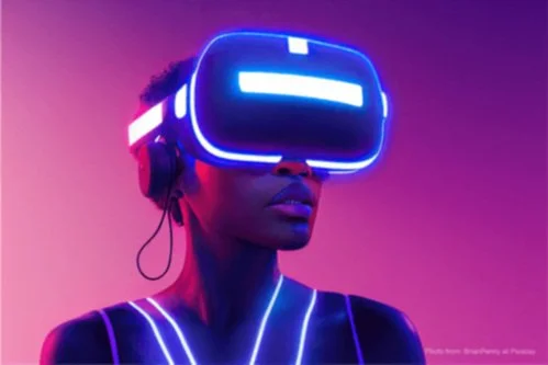 Person wearing virtual reality goggles with neon lights, in a colorful, futuristic setting.