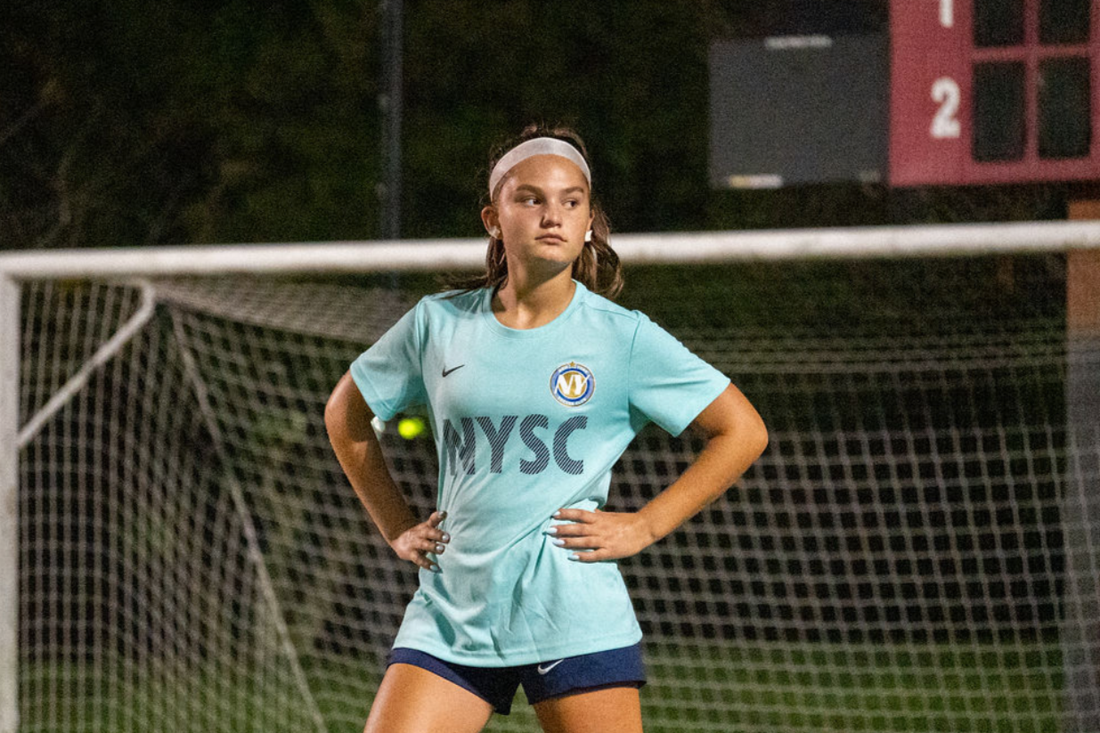 Focused player with hands on hips before a restart