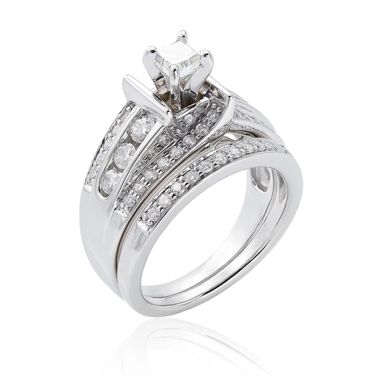 Diamond ring set on a white background with an added reflection