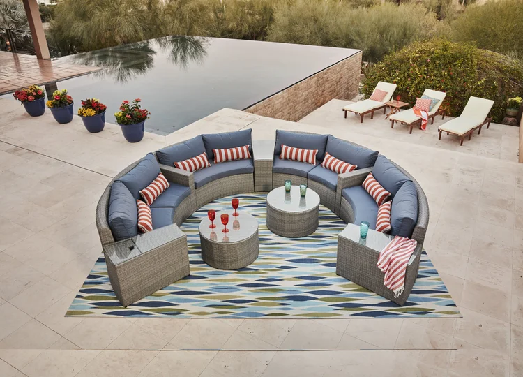Circular outdoor patio furniture set by a pool before retouching and color grading