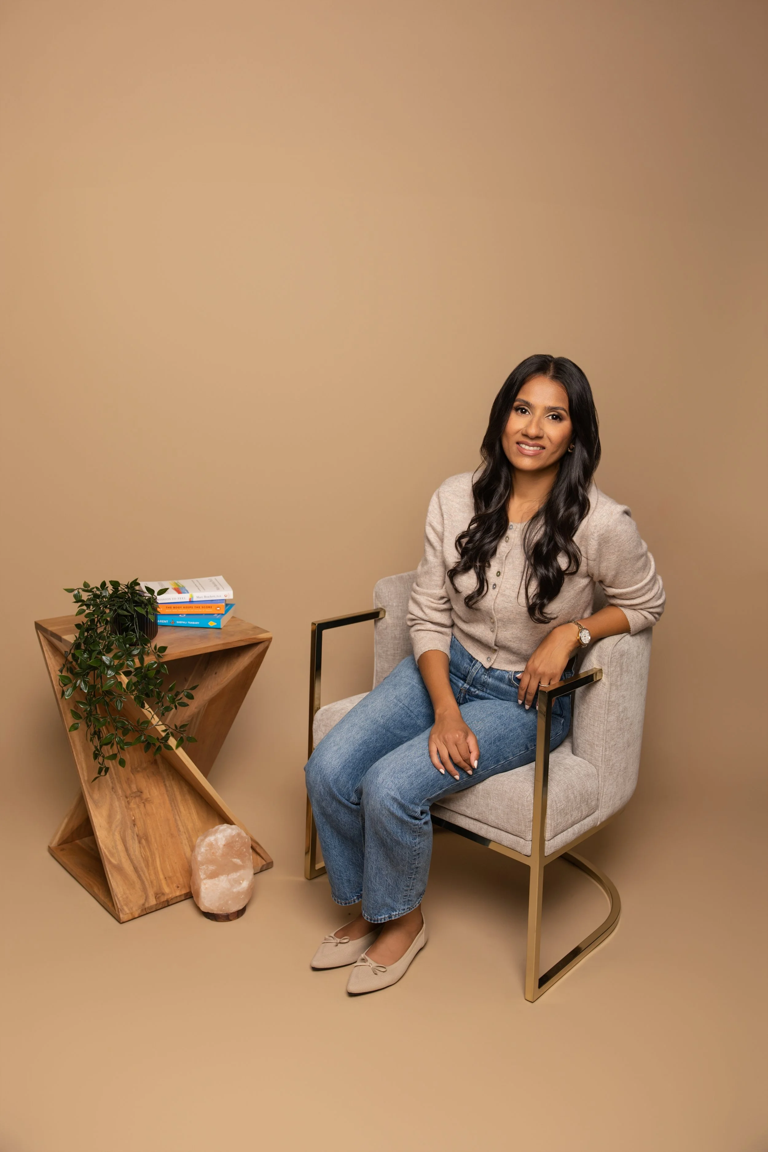 The principal counsellor at The Healing Cove, Ratiba Yasin, sitting in an armchair invitingly waiting to welcome a client.