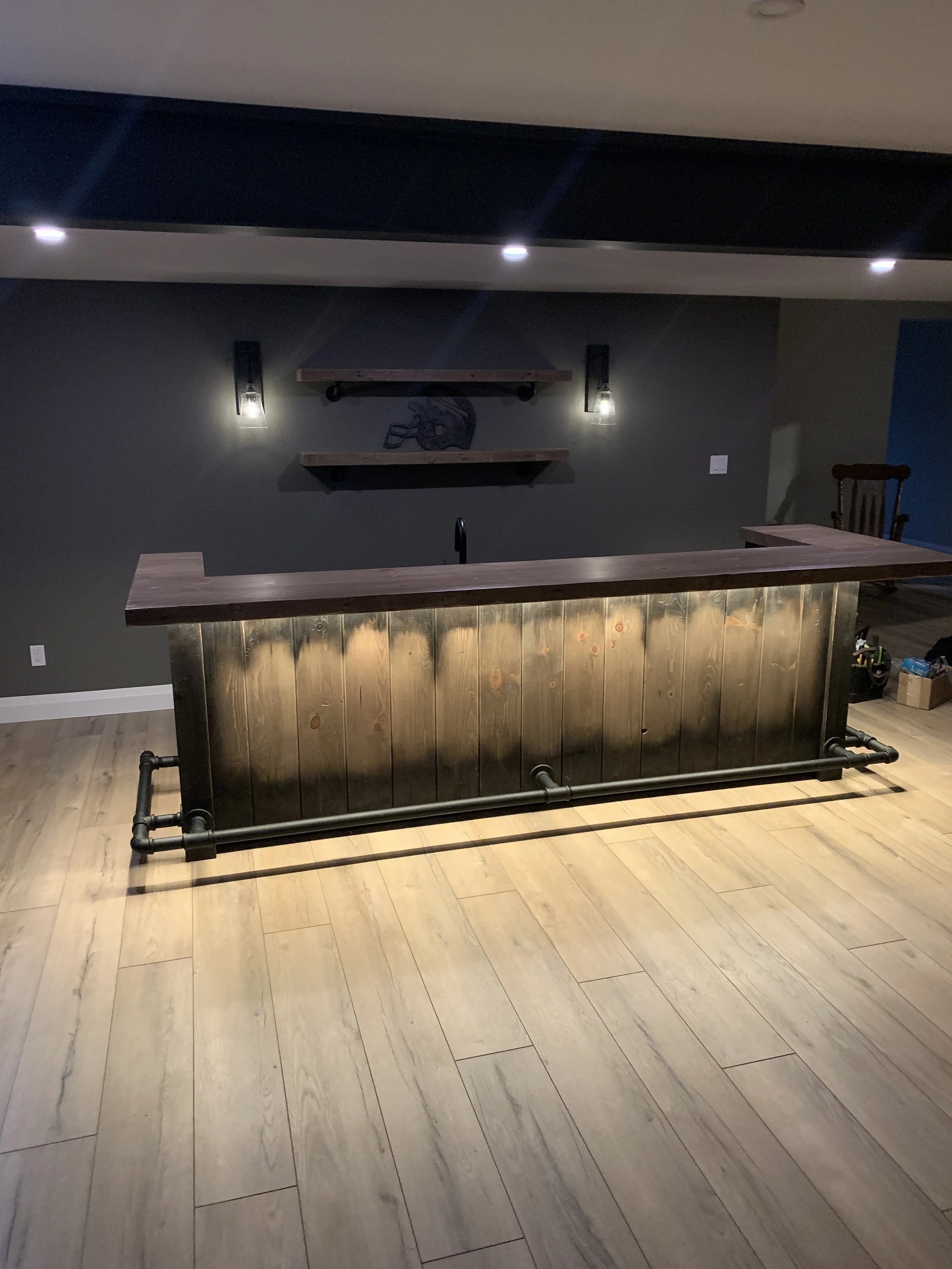 Home bar with under counter lighting, wall sconces and pot lights. 