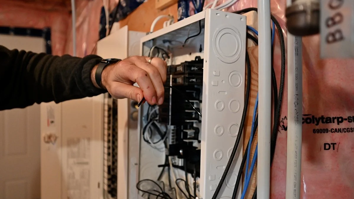 Electrician setting up a electrical panel.