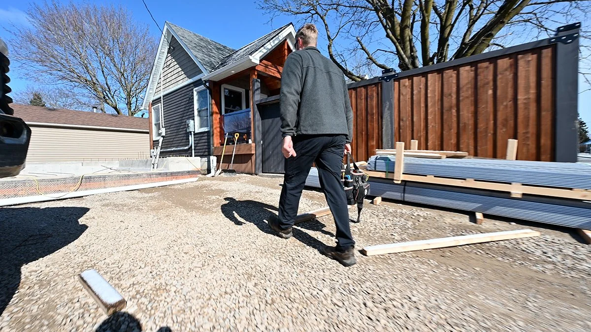 Electrician approaching a residential home. 