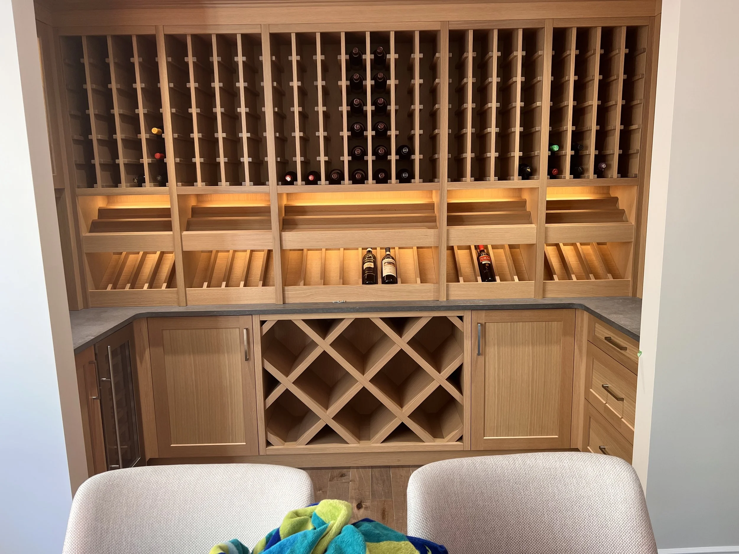 A well lit wine cabinet.