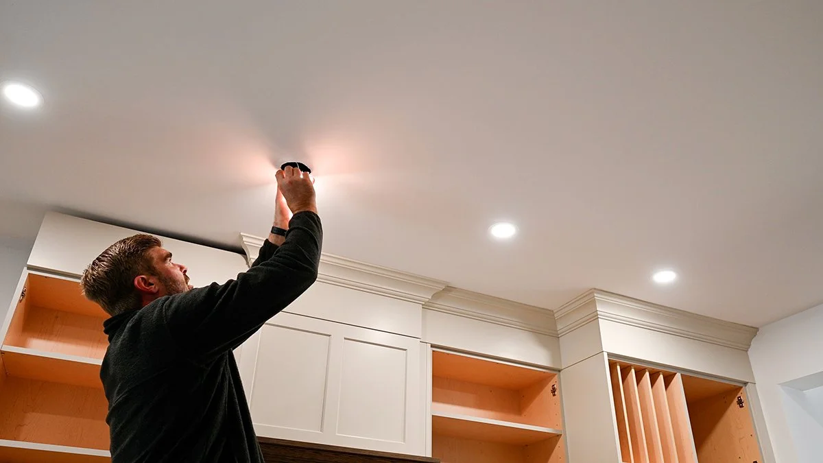 Electrician wiring pot lights.