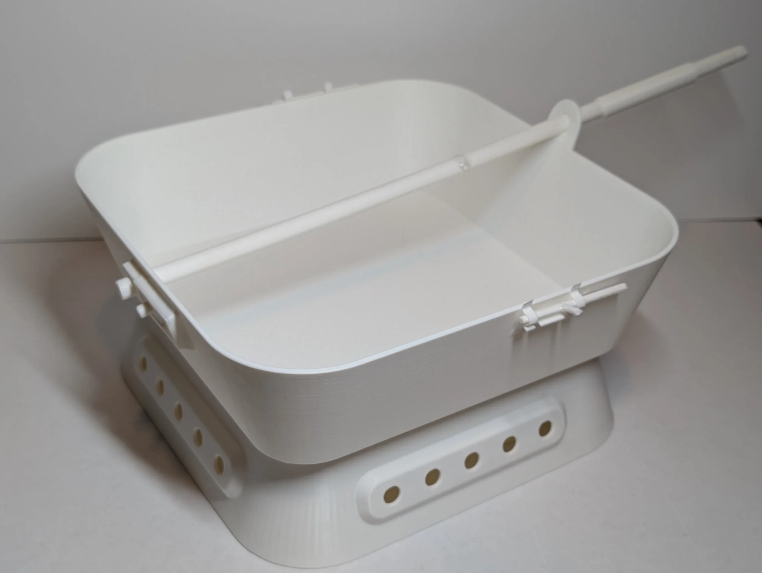 Place the pan on top and attach the handle from the hiking pole to the pan