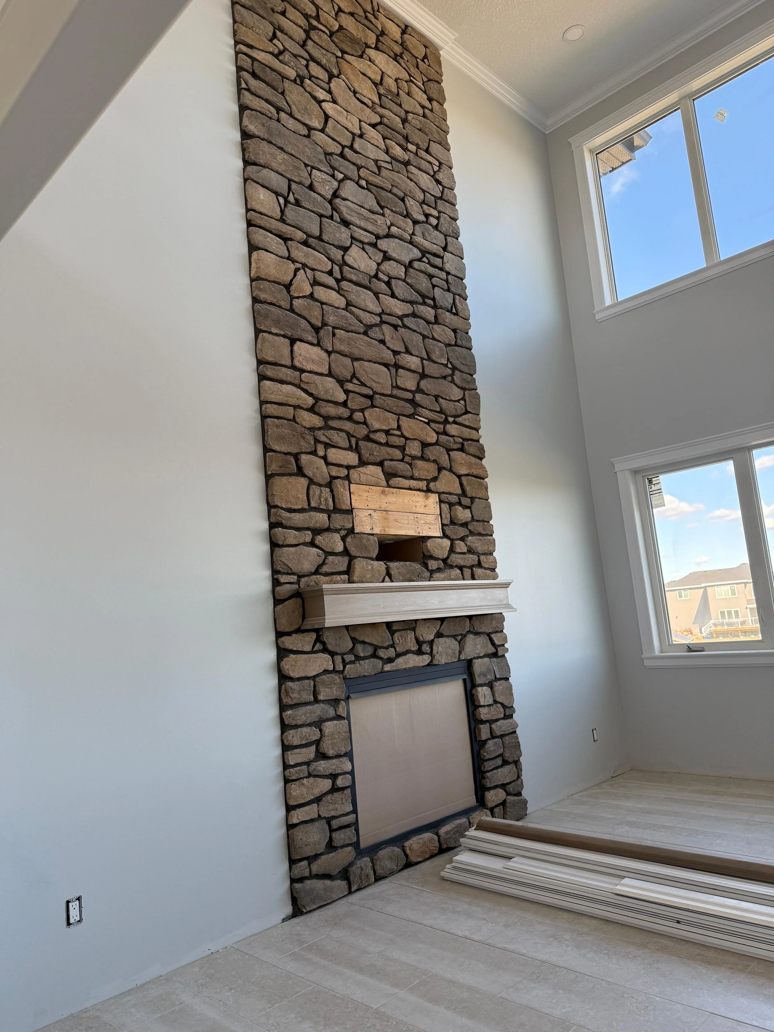 Close-up of wooden planks with visible knots and grain. The wood appears weathered and slightly grayish in color, laid out diagonally.
