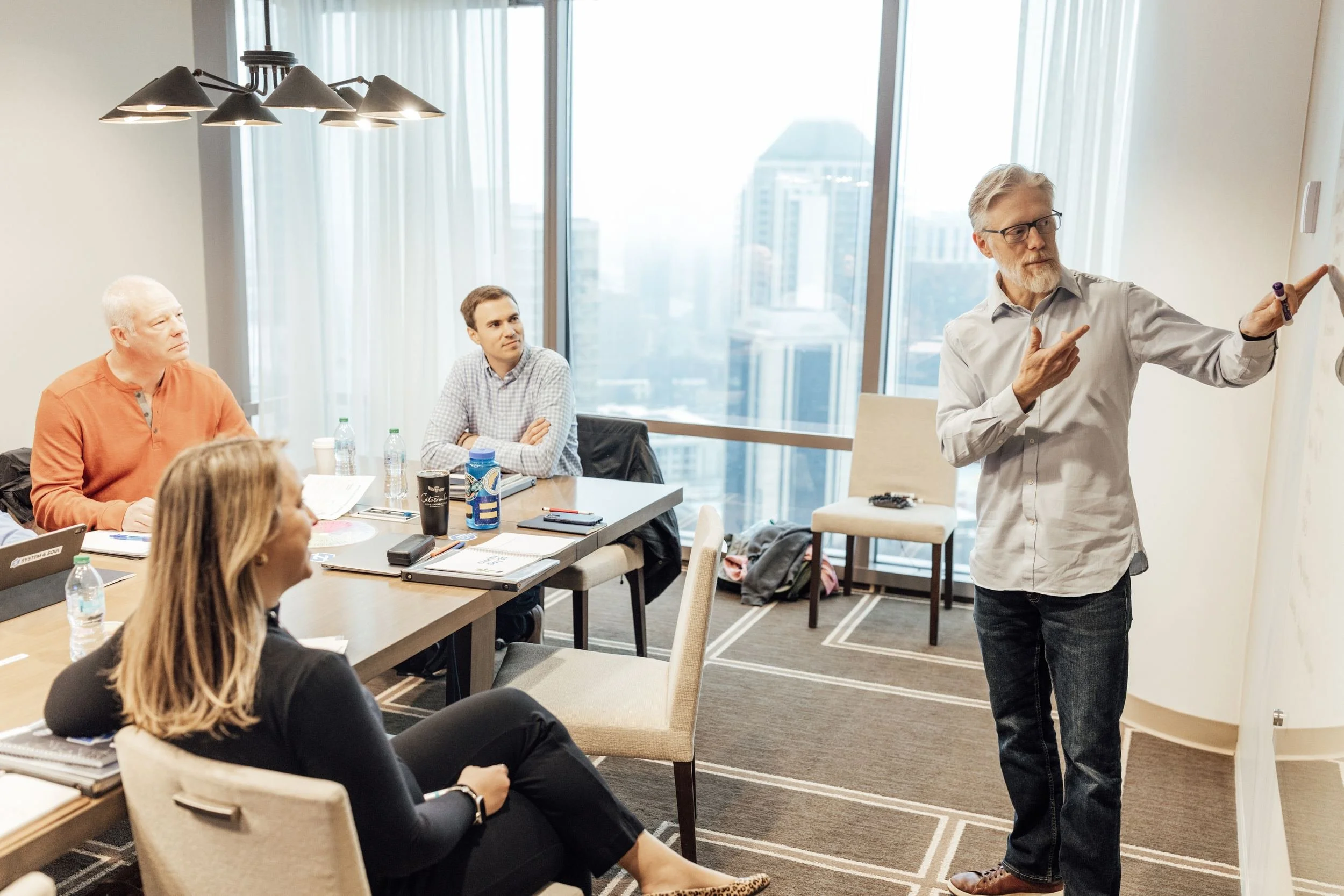 Danny Frazer leading a System and Soul workshop with a leadership team in a conference room