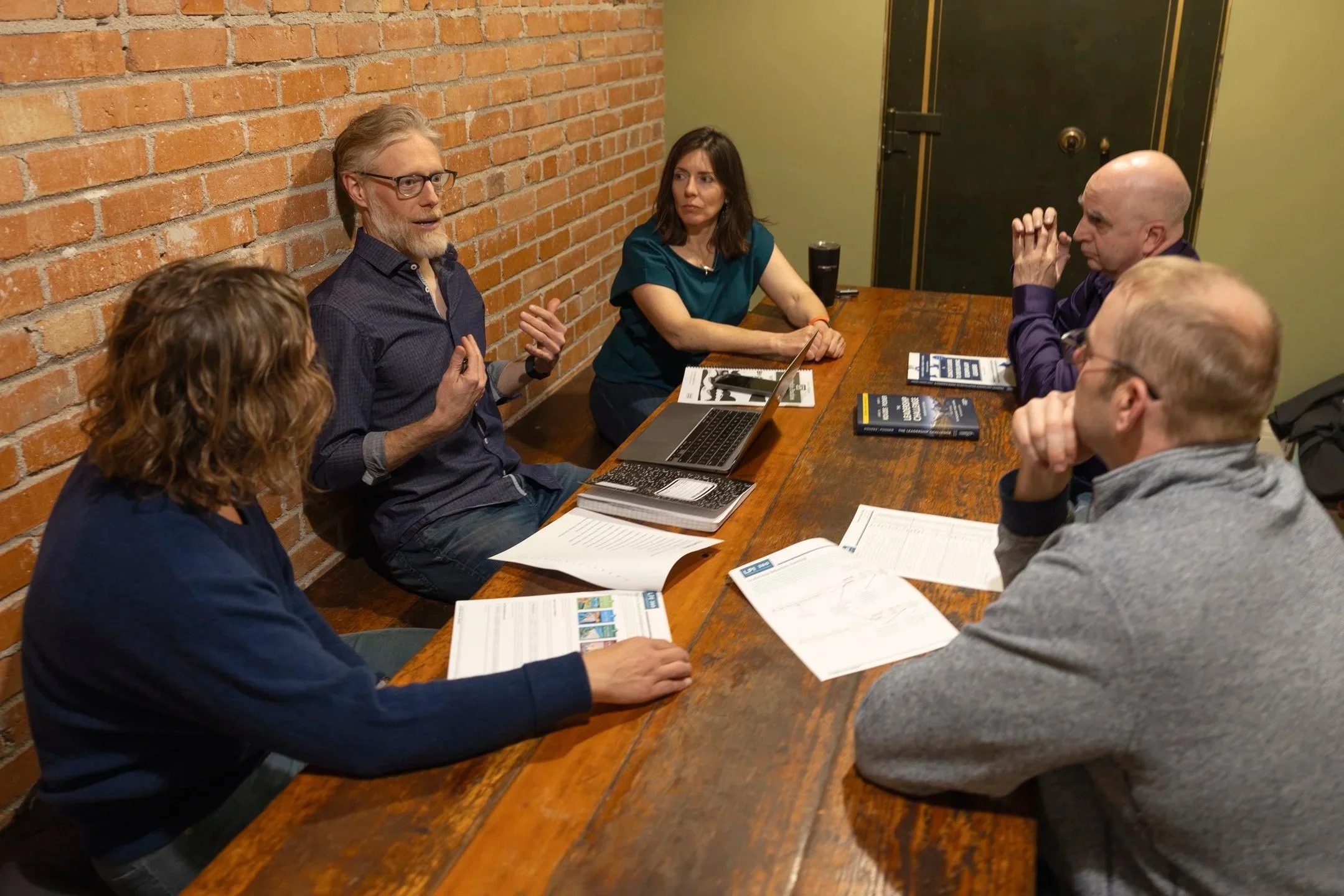 Danny Frazer leading an LPI 360 leadership workshop around a conference table
