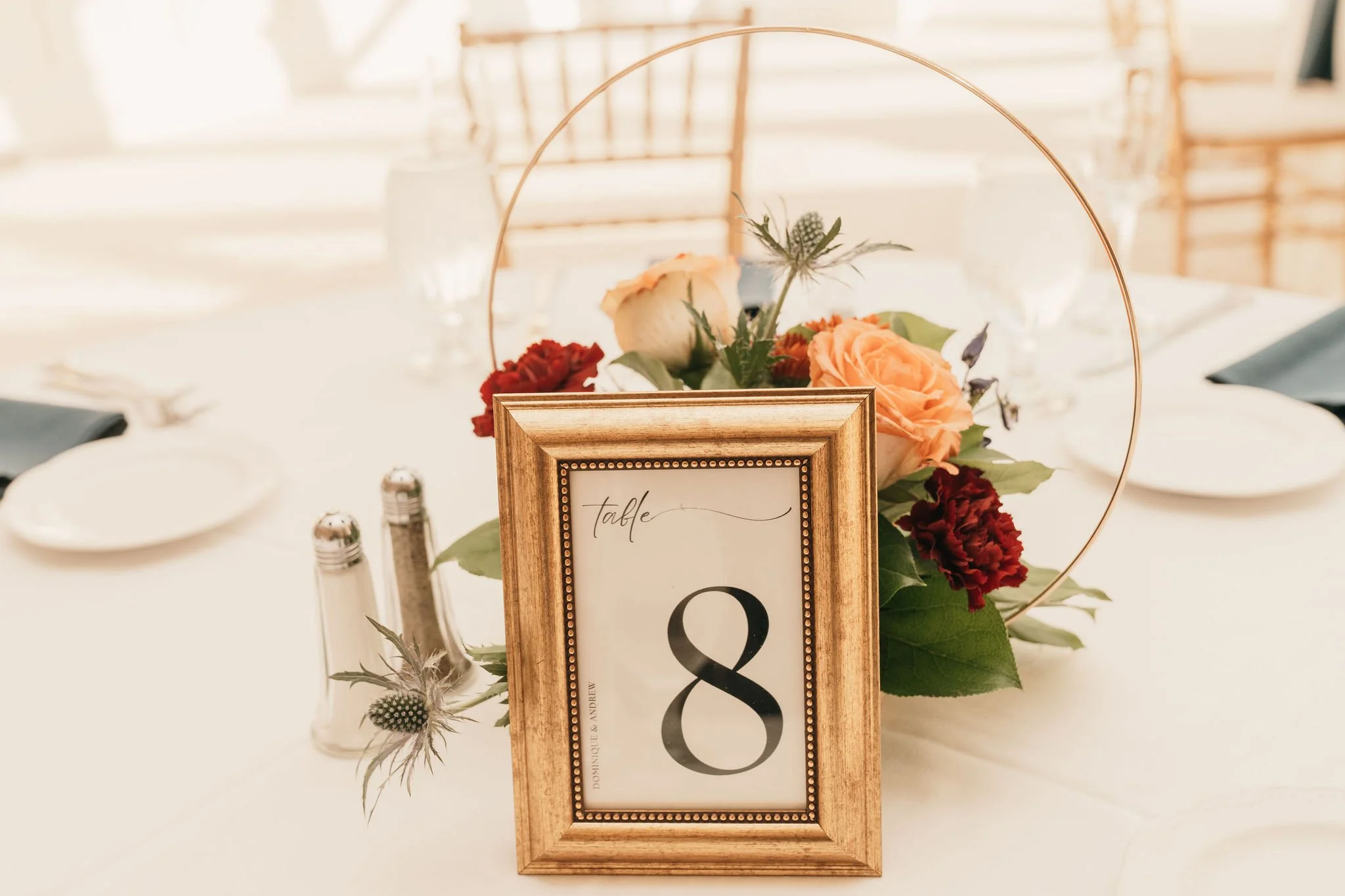 Table number 8 with floral centerpiece at a wedding reception table.
