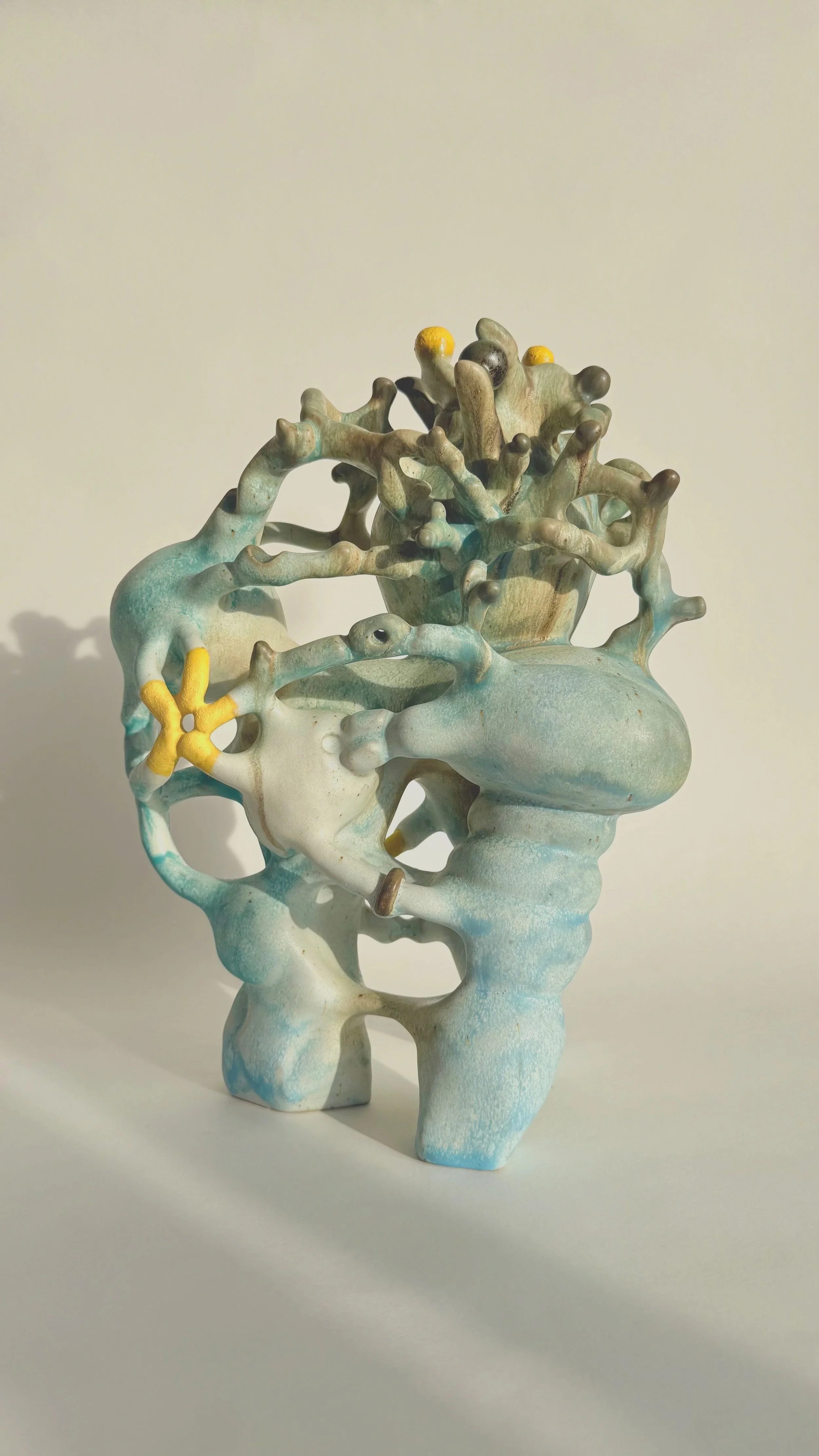 Hand-built stoneware sculpture El Cargador on a neutral background.