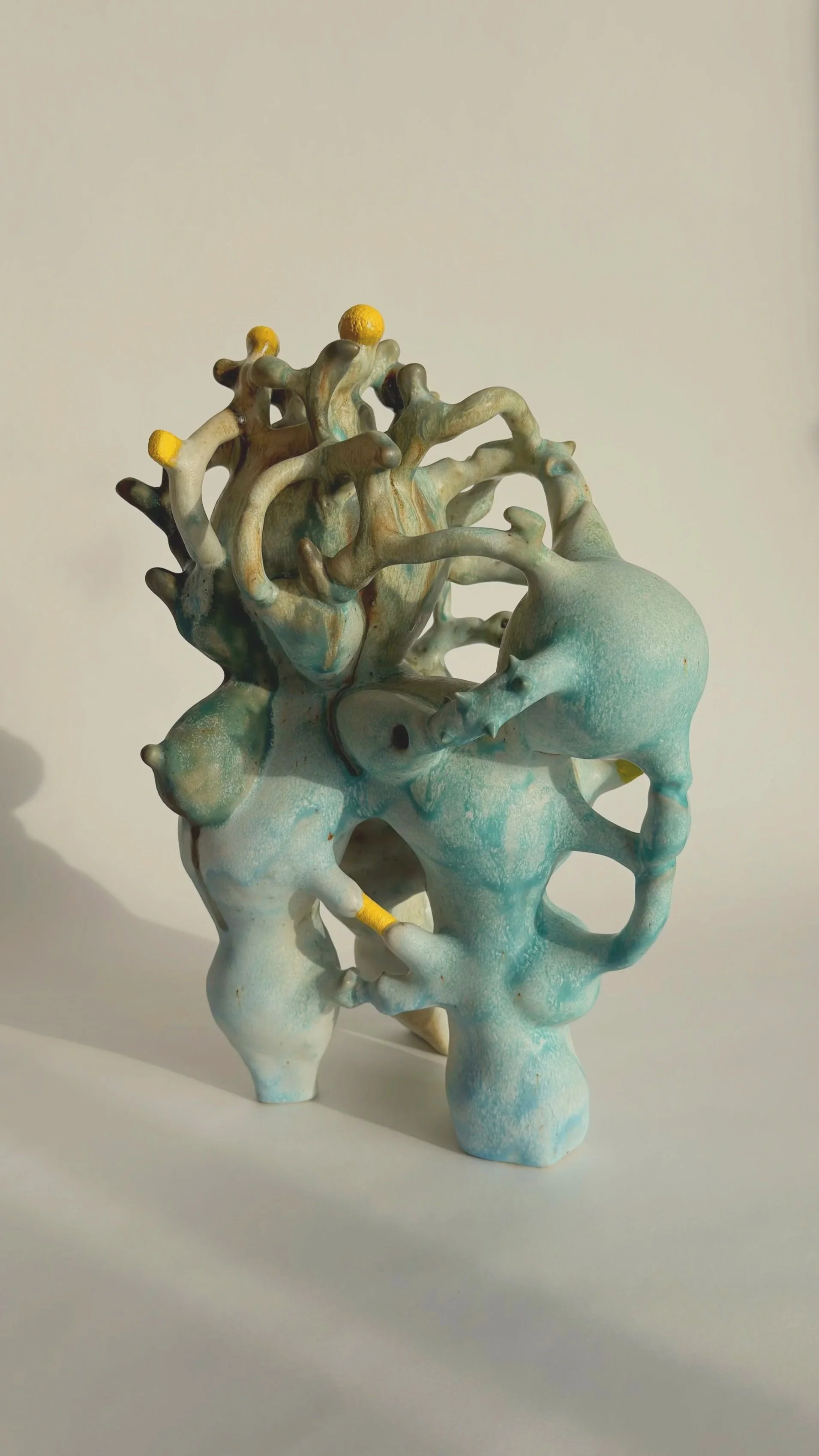 Hand-built stoneware sculpture El Cargador on a neutral background.