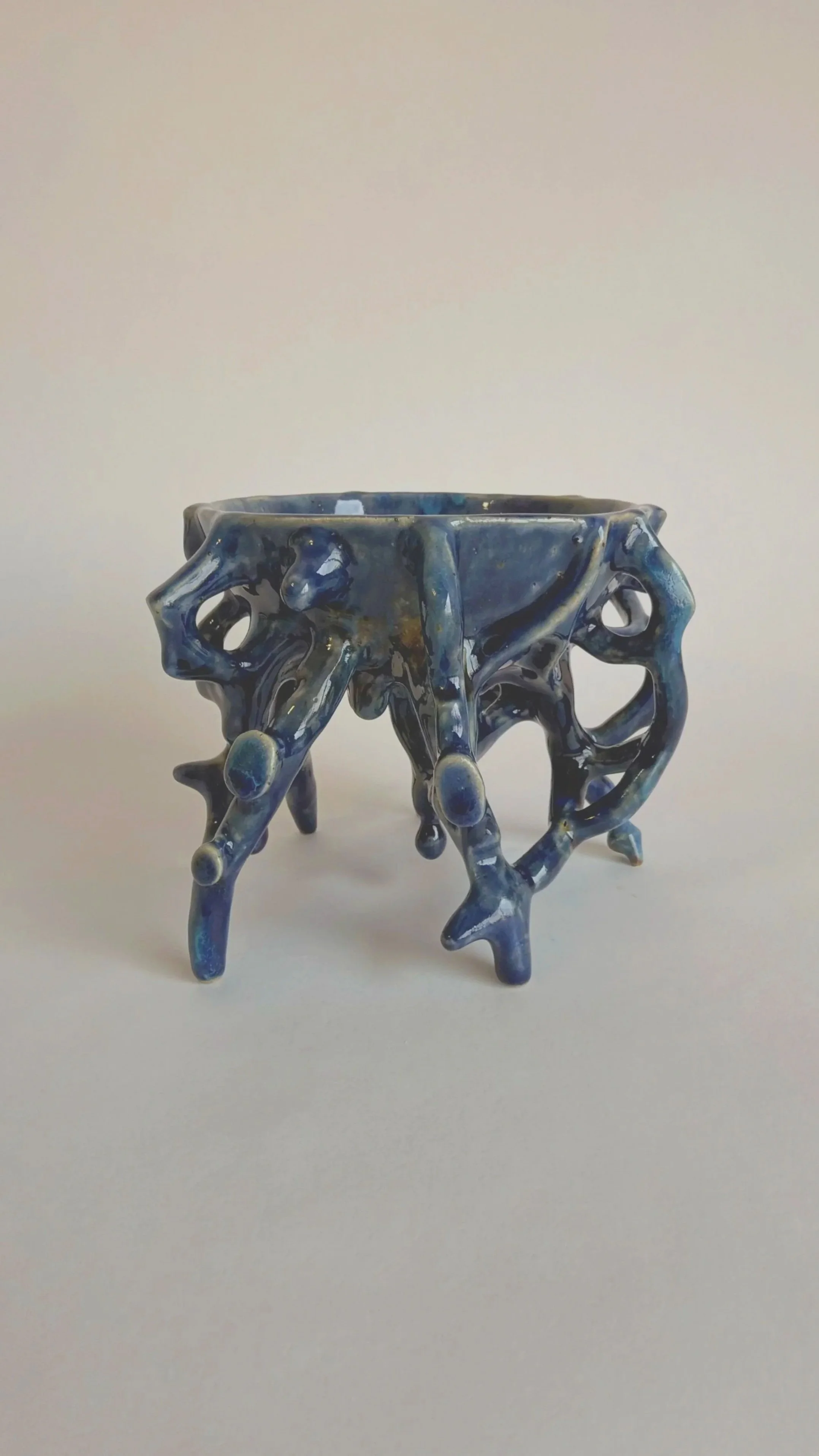 Side view of a hand-built blue stoneware bowl.