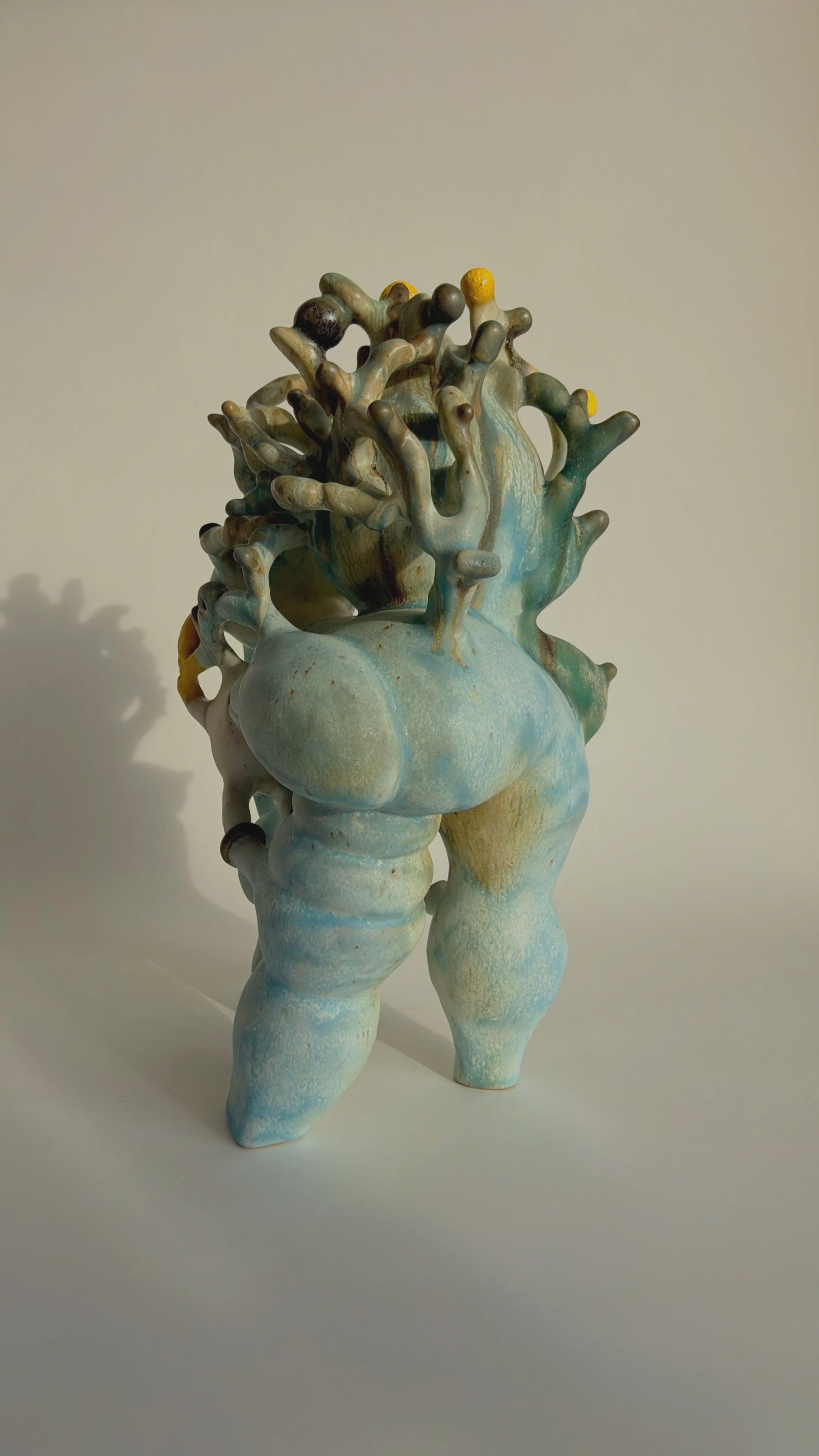 Hand-built stoneware sculpture El Cargador on a neutral background.