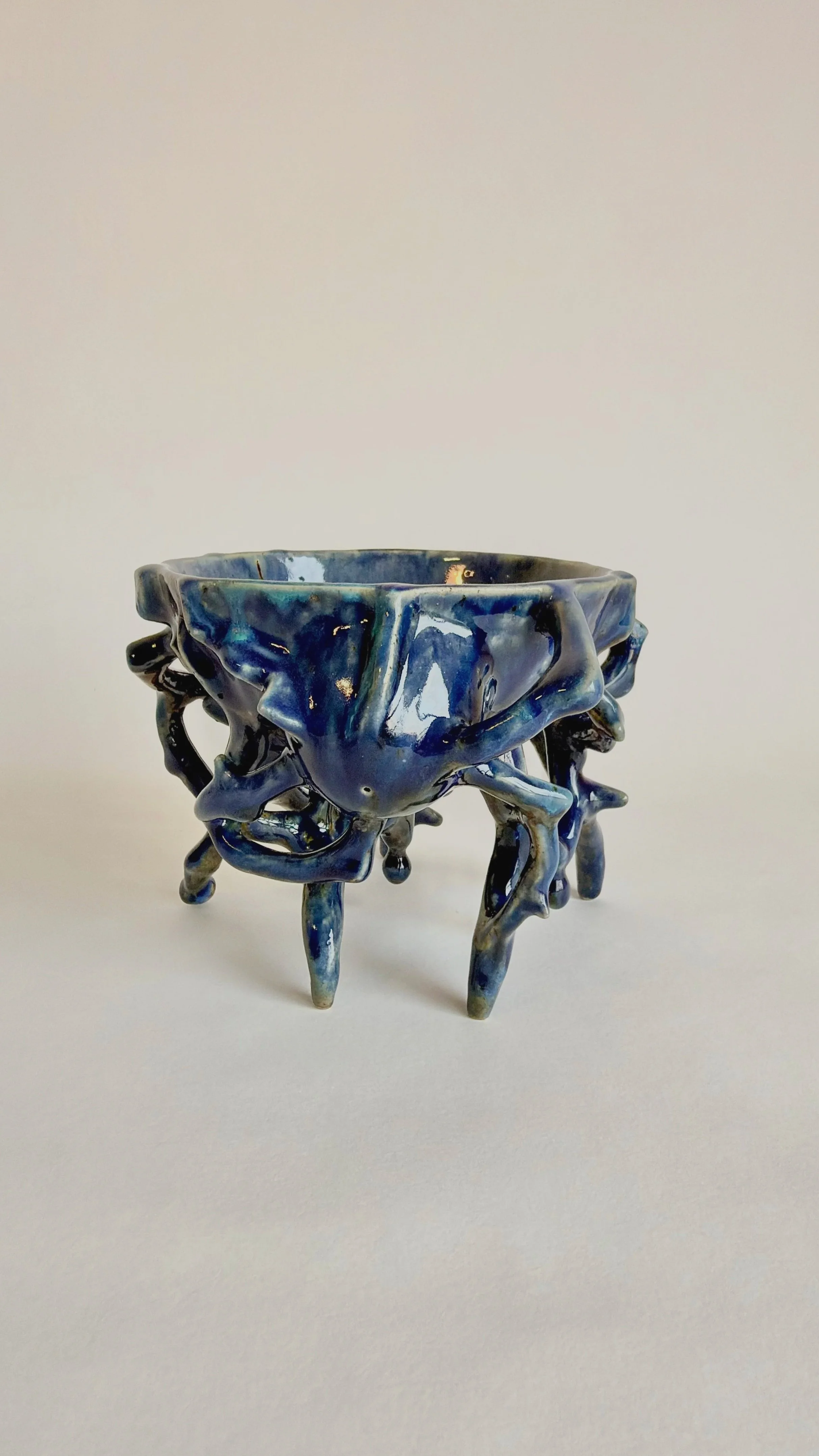 Side view of a hand-built blue stoneware bowl.