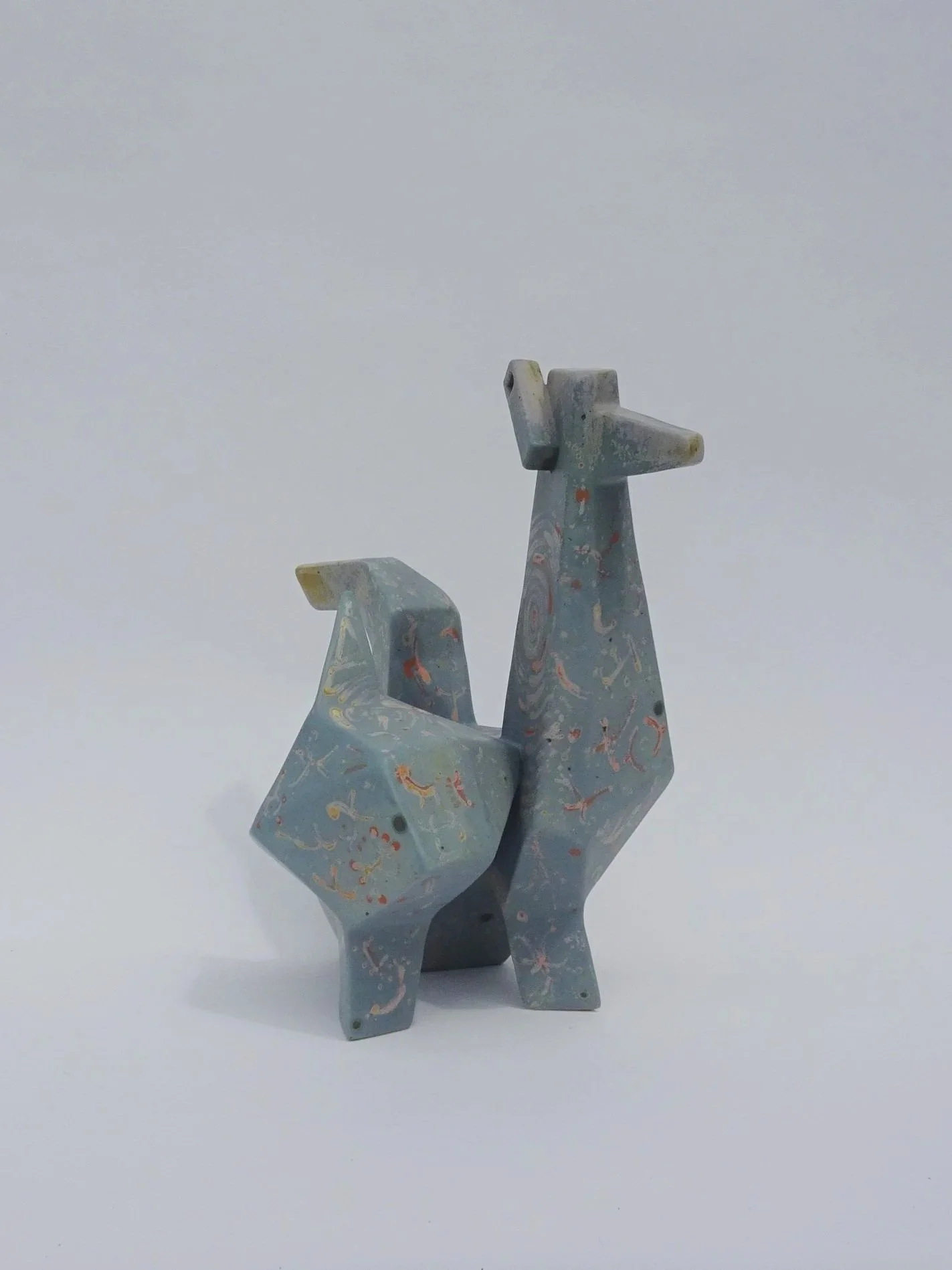 Hand-built ceramic sculpture Quantum Friend placed on a neutral surface.