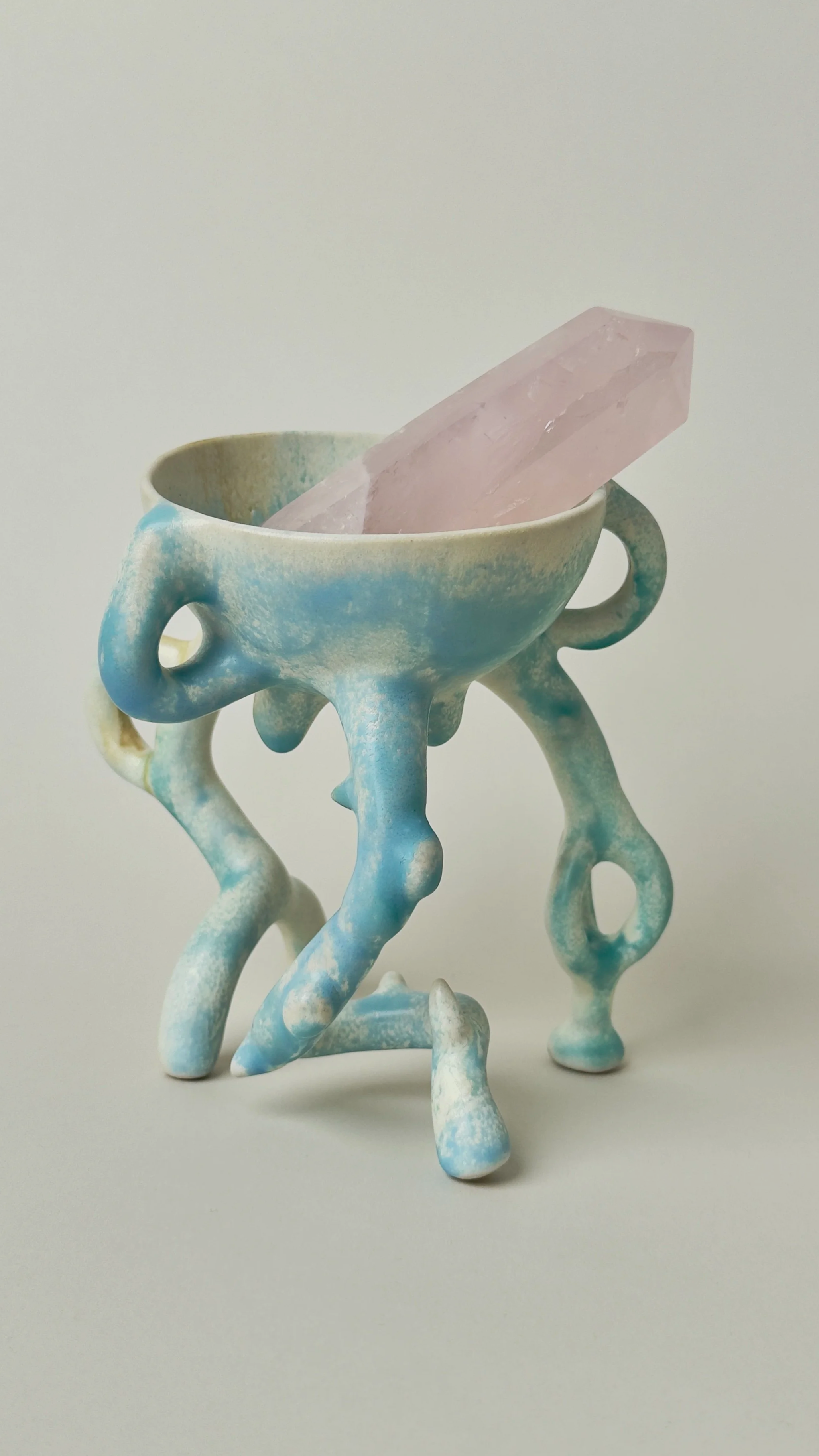 Hope Bowl, sculptural ceramic bowl with an organic four-legged structure and a soft blue and white glaze.