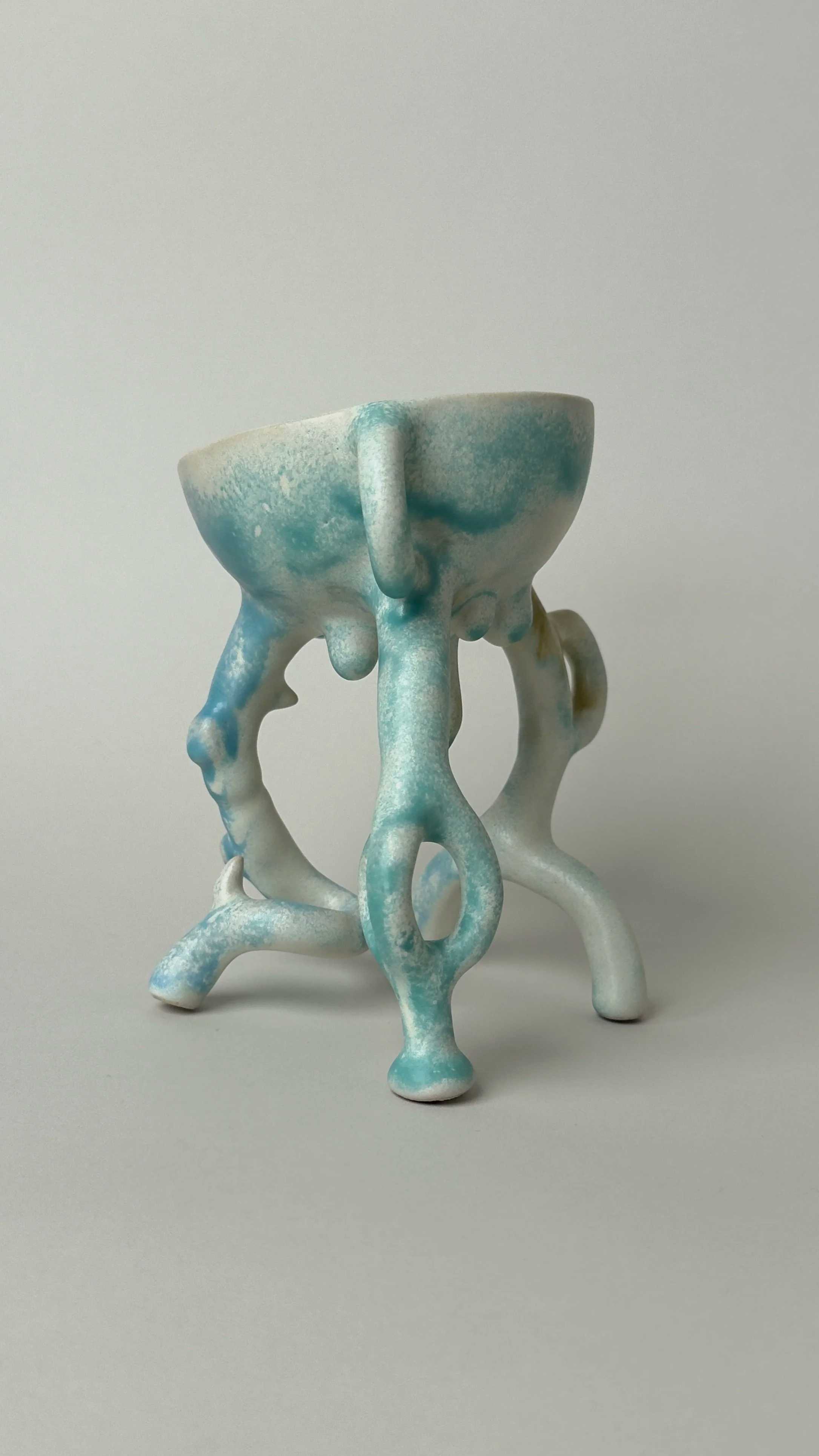 Hope Bowl, sculptural ceramic bowl with an organic four-legged structure and a soft blue, white and brown glaze.
