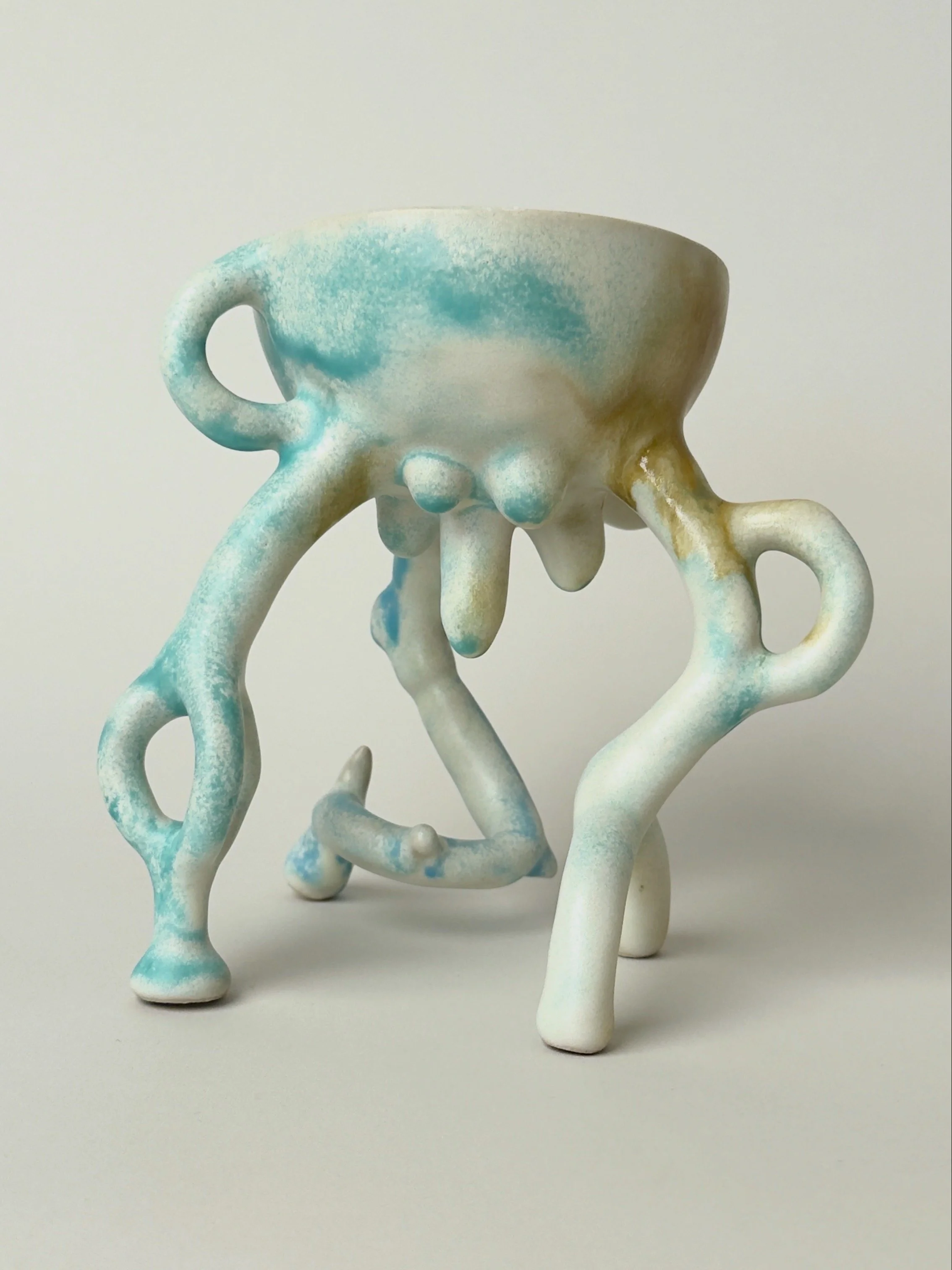 Hope Bowl, sculptural ceramic bowl with an organic four-legged structure and a soft blue, white and brown glaze.