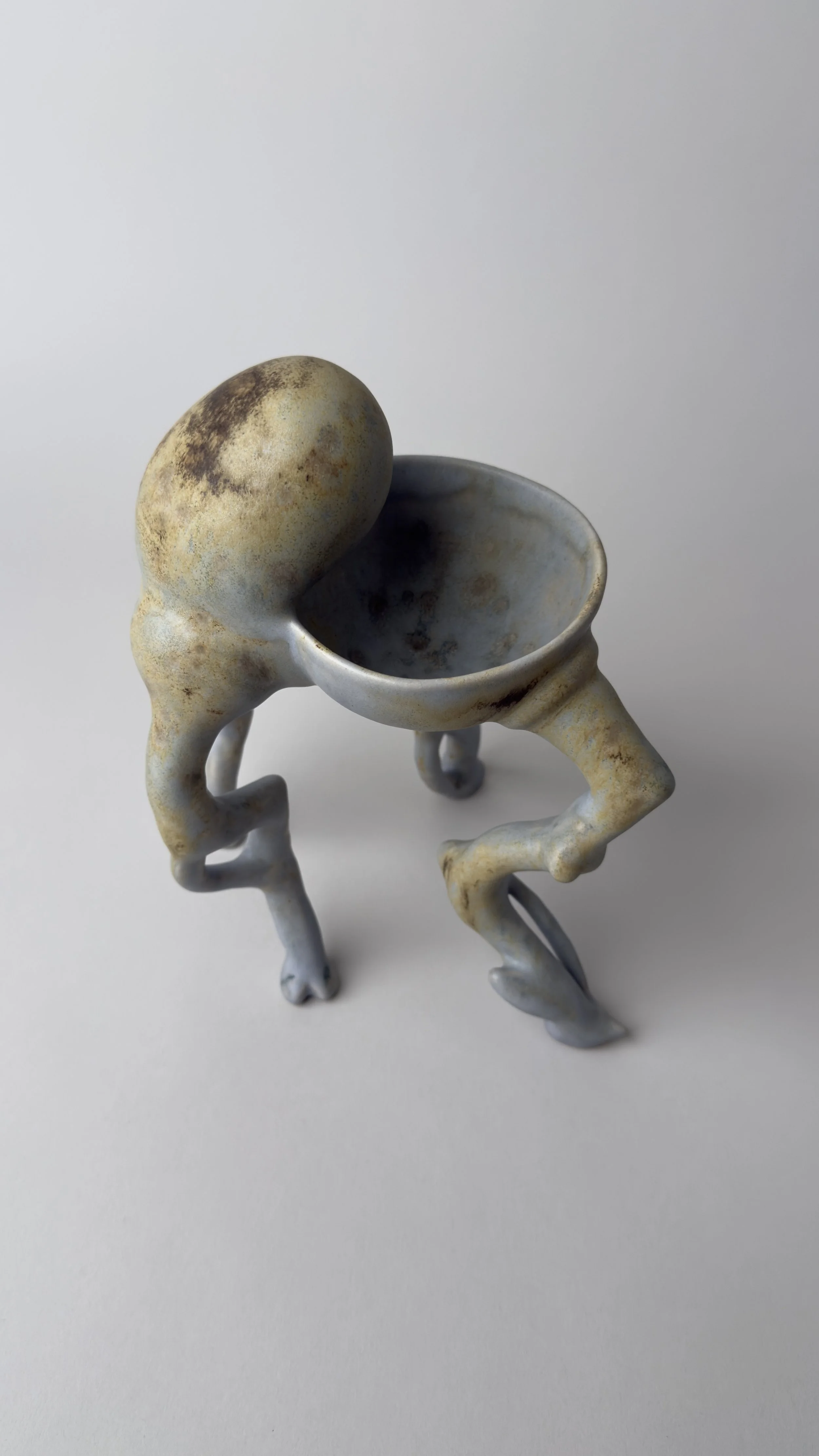 Crisálida Bowl, sculptural ceramic bowl with four organic legs and a rounded egg-like form rising from the back.