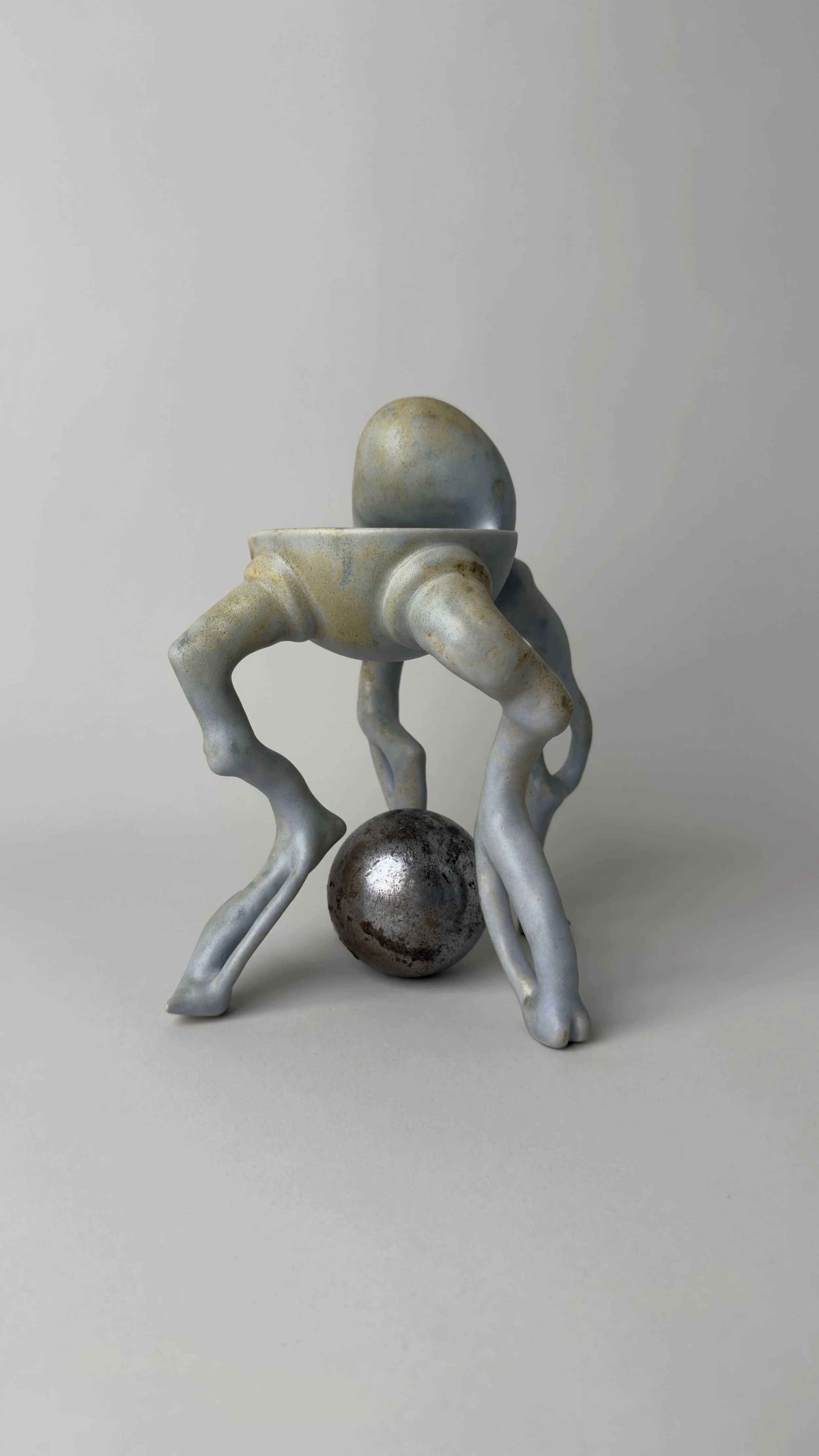 	
Crisálida Bowl, sculptural ceramic bowl with four organic legs and a rounded egg-like form rising from the back. With a metallic sphere in between its legs.