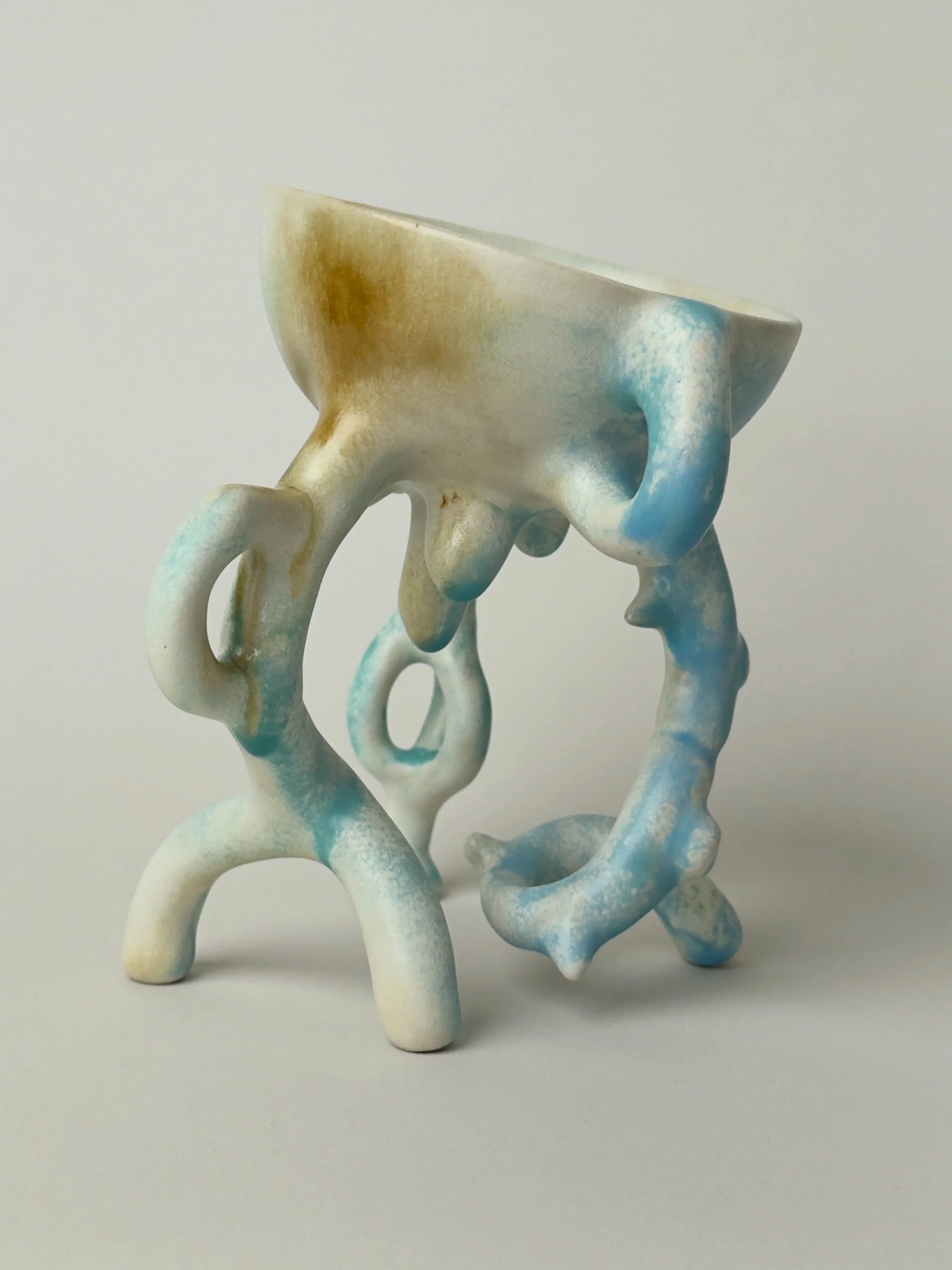 Hope Bowl, sculptural ceramic bowl with an organic four-legged structure and a soft blue, white and brown glaze.