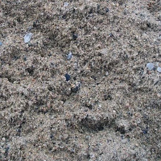 Close-up of sandy dirt with small pebbles and rocks.