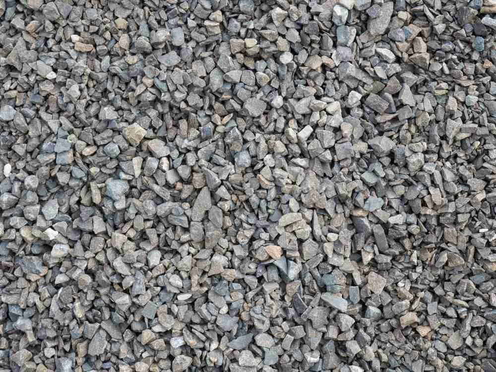A close-up view of a large pile of small gray and brown gravel stones.