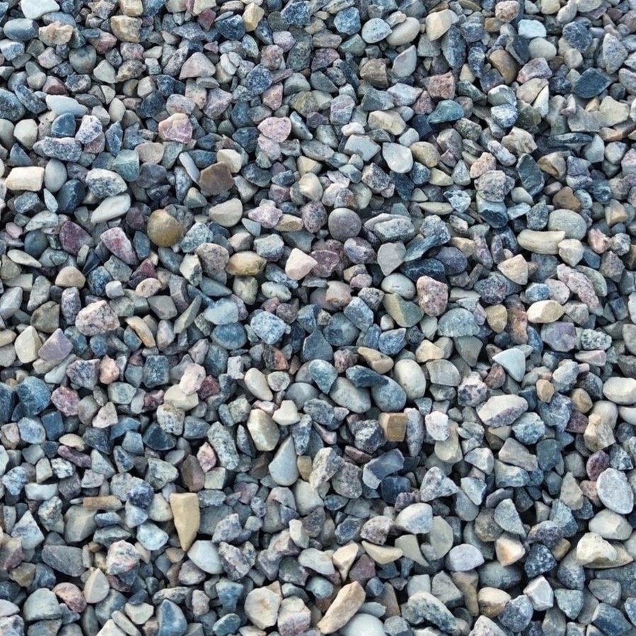 A close-up view of various small, rounded stones and gravel, featuring multiple shades of gray, tan, and pink.